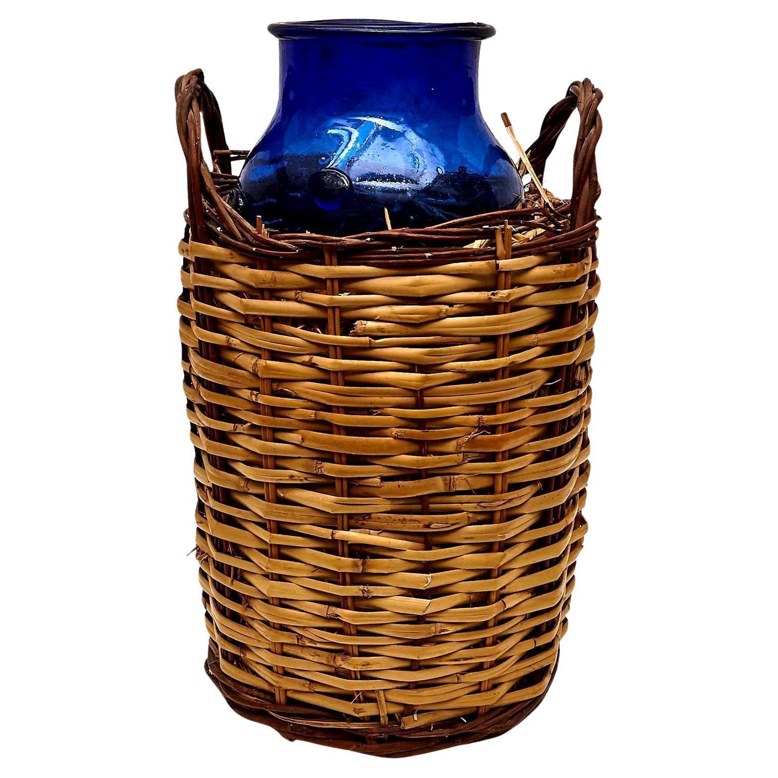 Blue Glass Bottle with Wicker Basket, circa 1930 For Sale