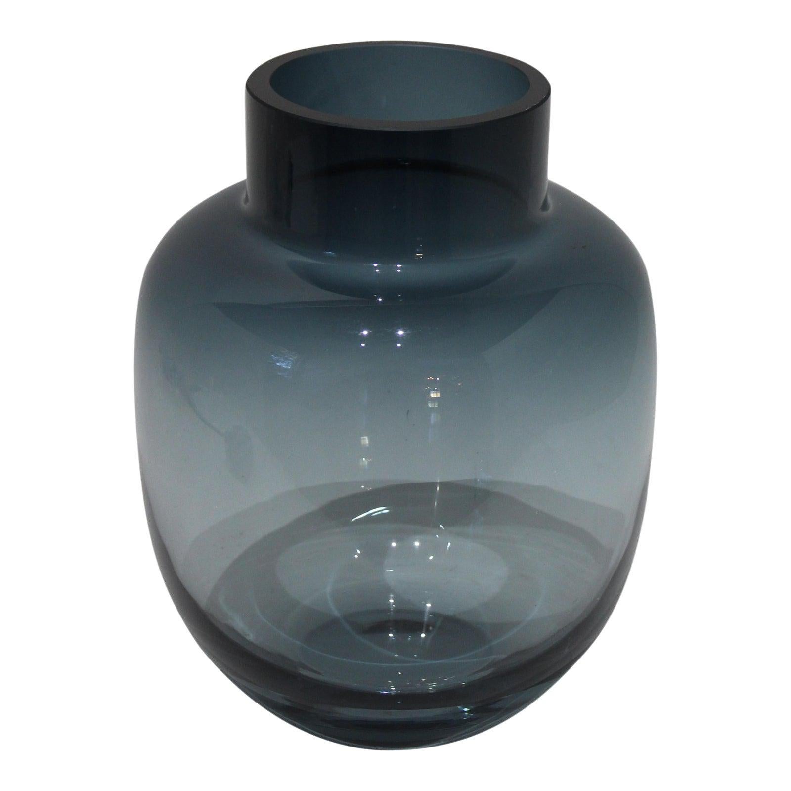 This stylish steel blue colored glass vase dates to the 1960s-1970s and was created by Holmegaard of Denmark.