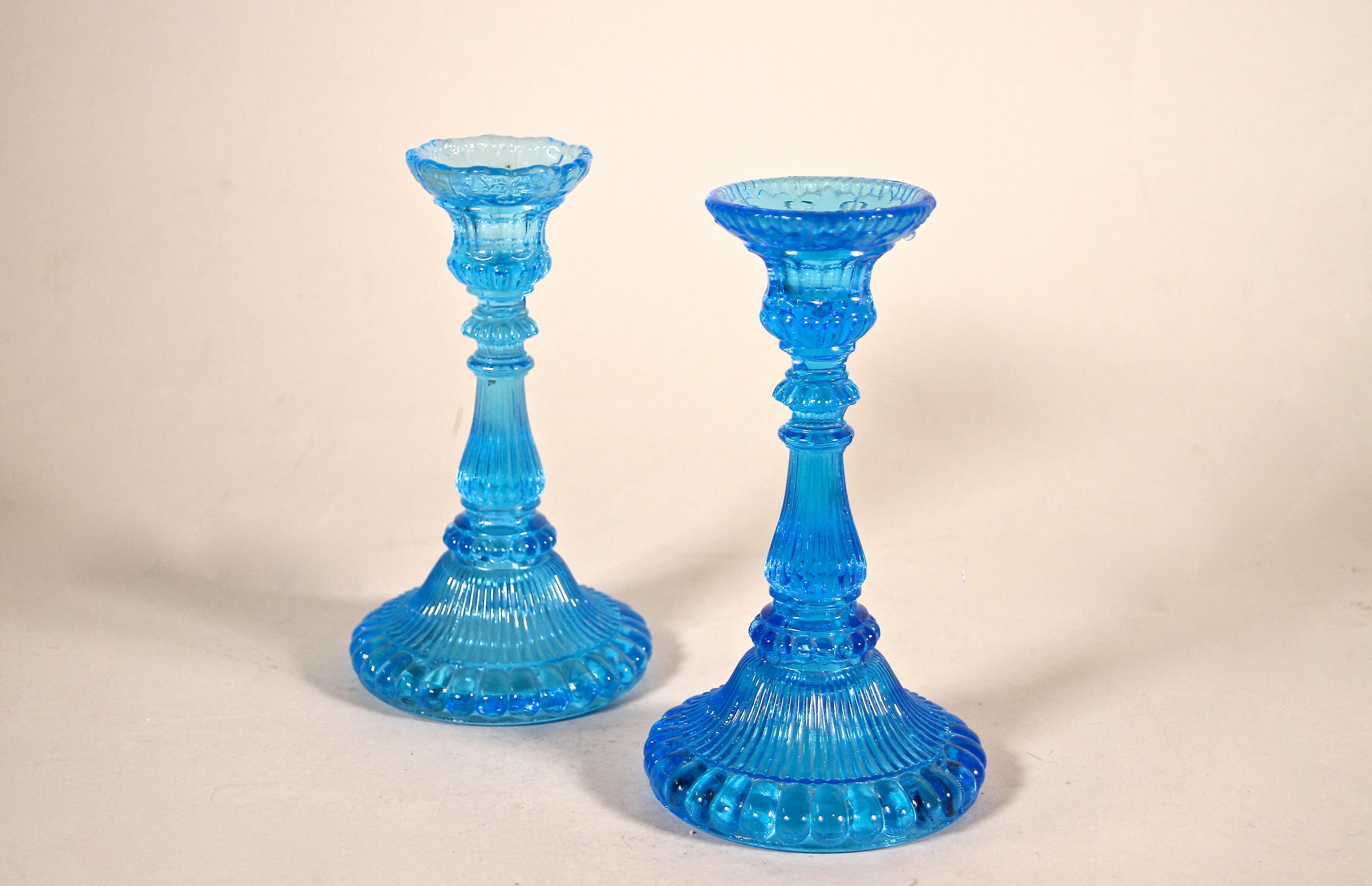 Lovely Blue Glass Candle Holders from the Art Deco period around 1920 in Austria. Artfully made of pressed blue colored glass, these two candlesticks show a real nice design adorned by beautiful lines. Fantastic decoration items for a table or a