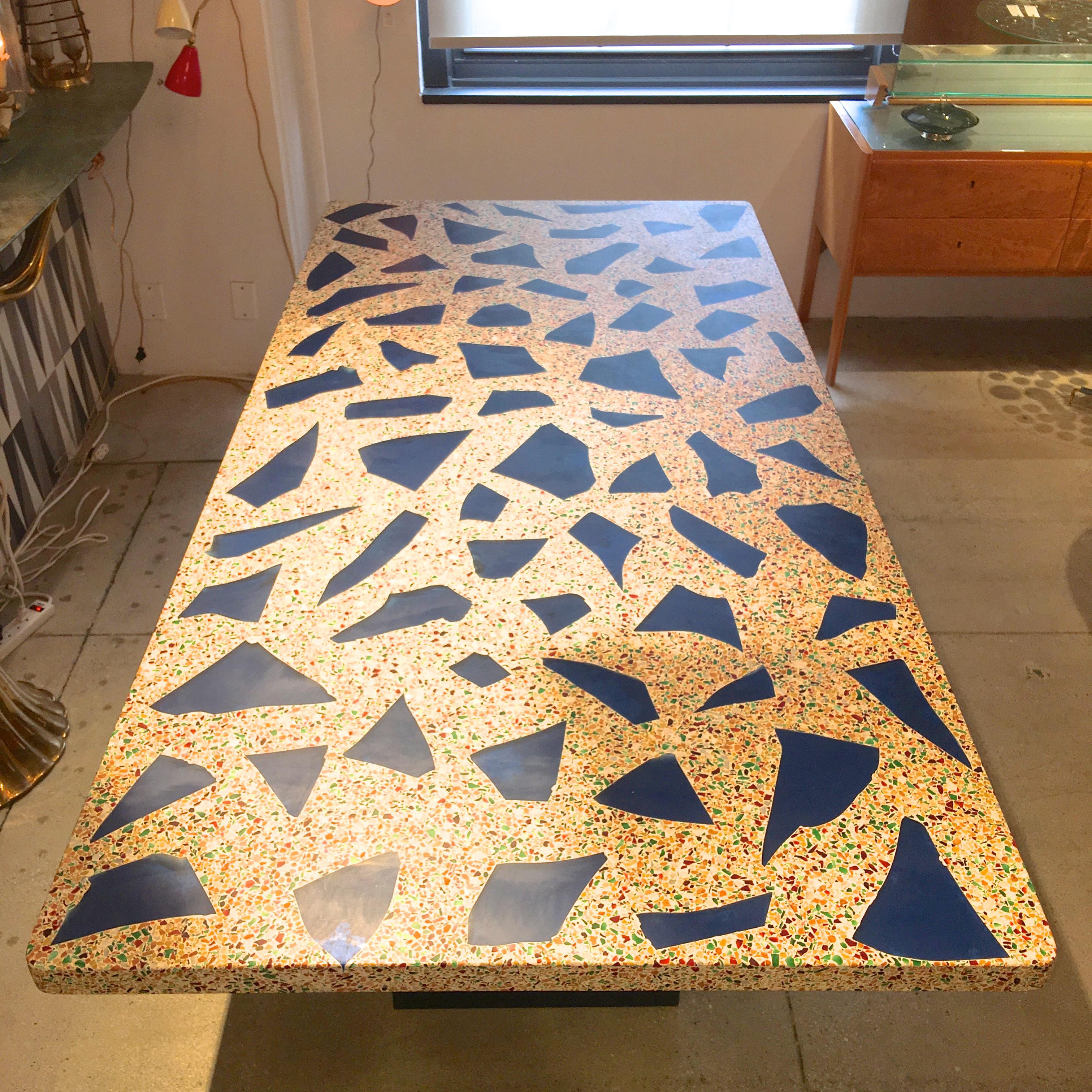 Amazing vintage solid terrazzo stone slab with a hundred or so irregularly shaped chunks of blue glass inset amongst the mix of smaller pieces of colored glass and stone. Top is 2 inches thick. The underside is polished as well without the large