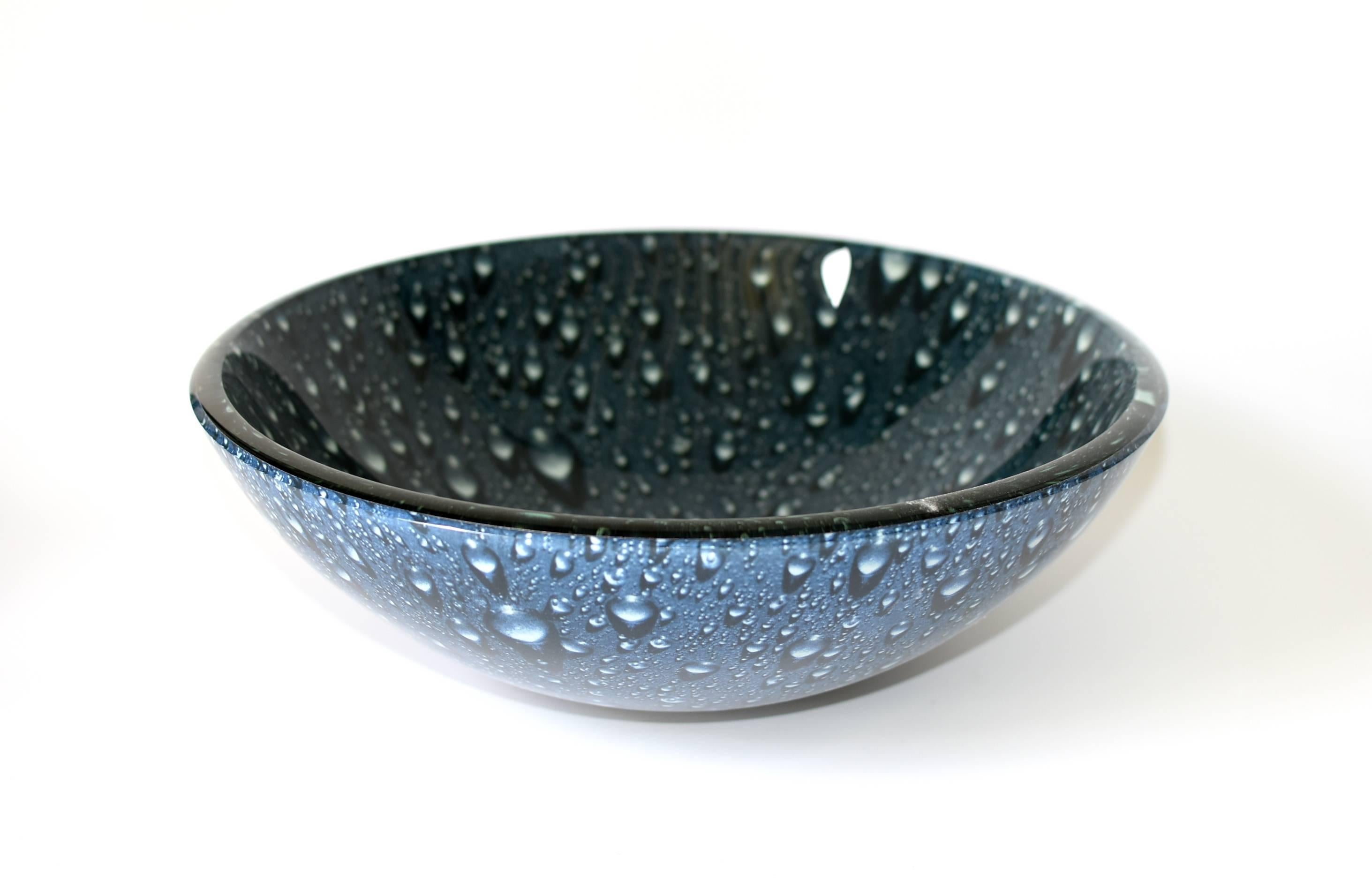 Beautiful dark blue glass sink with a rain drop pattern and a lighter blue exterior. The sink is heavy and substantial, rings like crystal. The rain drop pattern adds a modern and romantic touch to the piece. The bowl is glass, wider, lower height