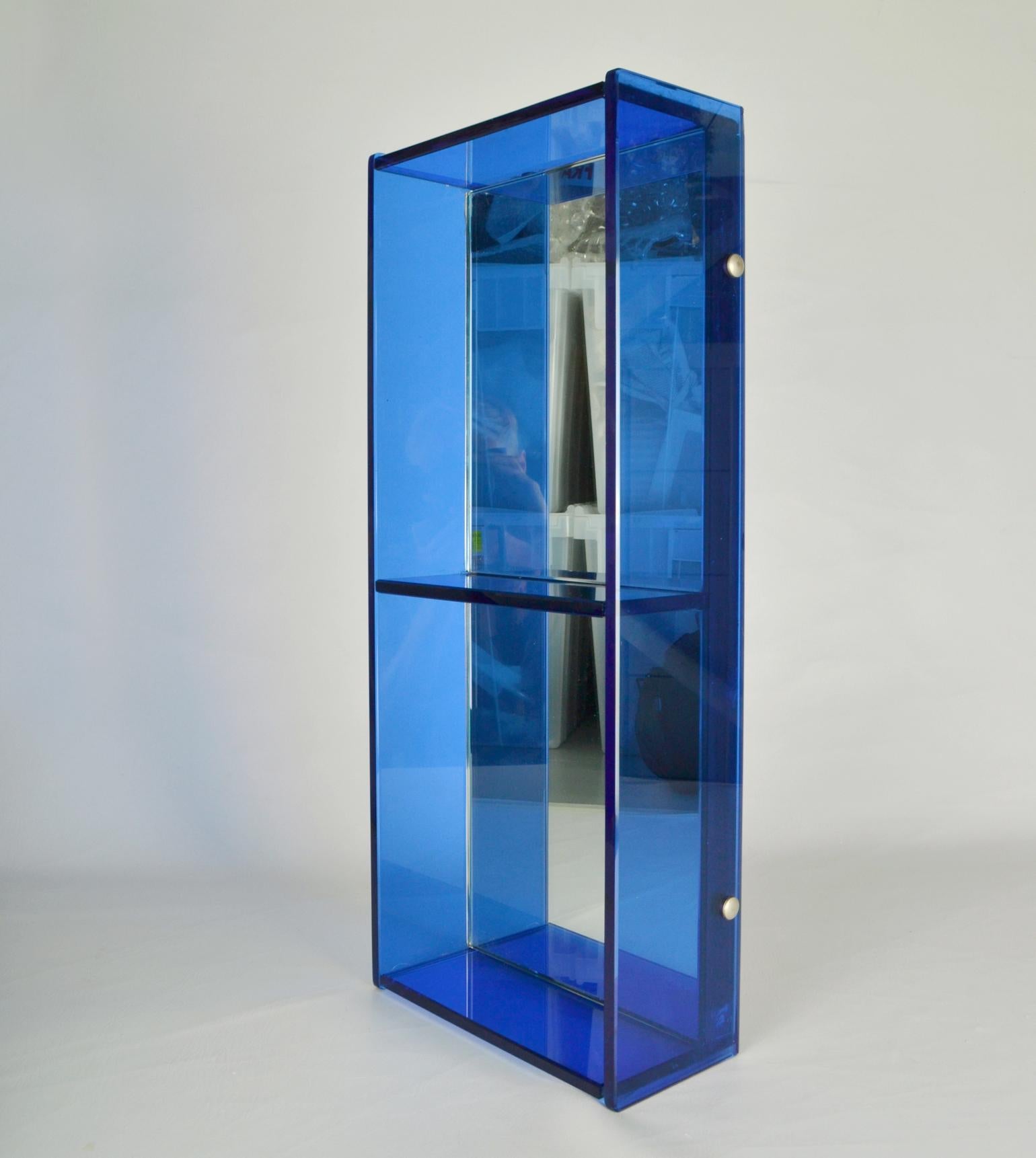 Blue christal glass mirror & wall shelf attributed to Fontana Arte / Cristal Arte, 1960's. The rectangular mirror has two square compartments with blue outer glass borders and a back mirror. 
Vertical or horizontal hung mirror is perfect for a