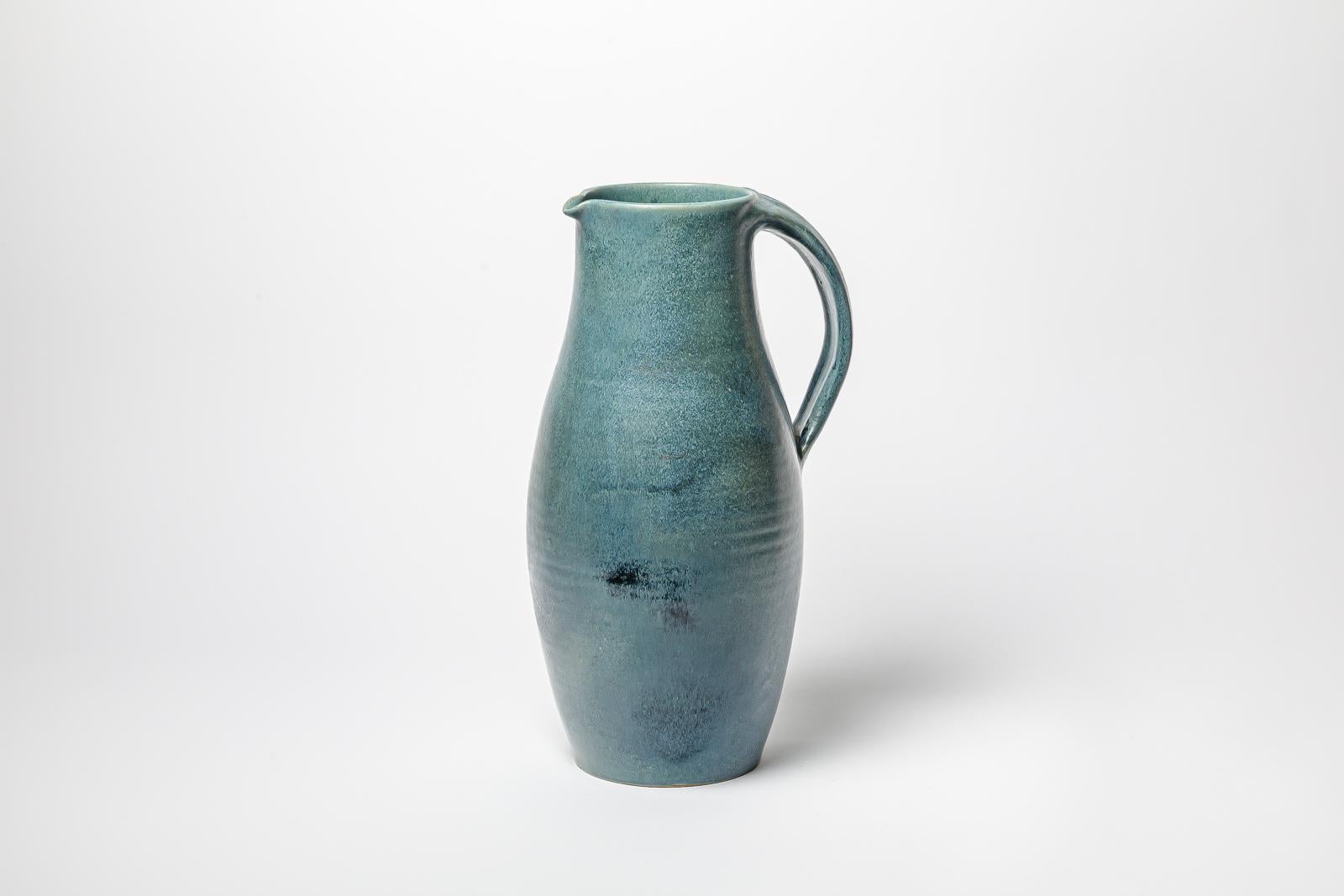 Blue glazed ceramic pitcher by Roger Jacques. 
Artist signature under the base. Circa 1960-1970. 
H : 17.3’ x 9.8’ x 7.4’ inches.
