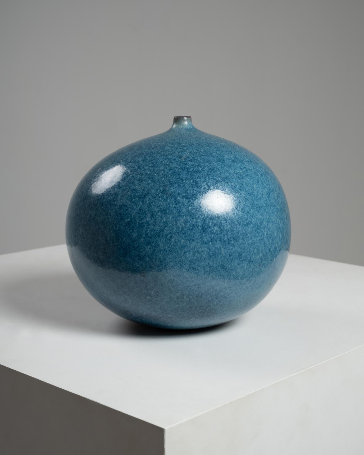 This elegant blue glazed ceramic vase was created by the celebrated French ceramicist duo Jacques (1926–2008) and Dani (1933–2010) Ruelland, known for their harmonious forms and mastery of vibrant glazes. Produced in France circa 1960, this