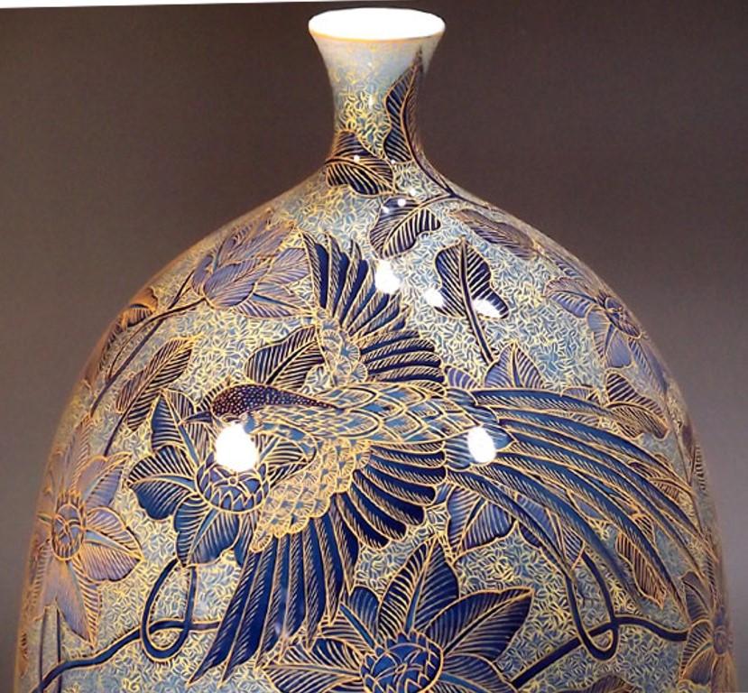 Extraordinary contemporary Japanese decorative porcelain vase, hand painted on a elegantly shaped porcelain body in blue, with extremely intricate patterns and extensive use of high purity gold, creating a mesmerizing palette with layers of