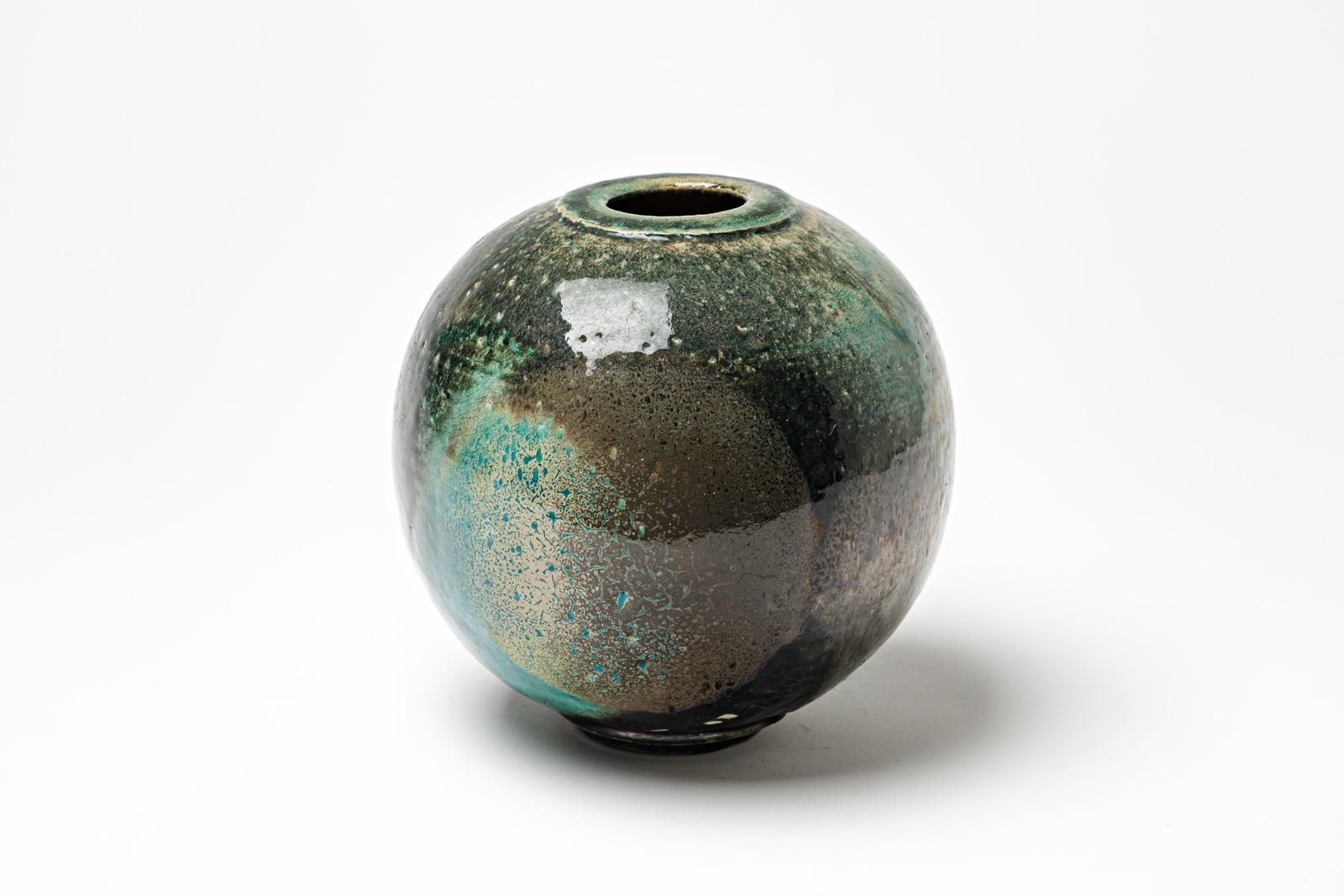 Blue/green and black glazed ceramic vase by Gisèle Buthod Garçon. 
Raku fired. Artist monogram under the base. Circa 1980-1990.
H : 7.5’ x 6.3’ inches.