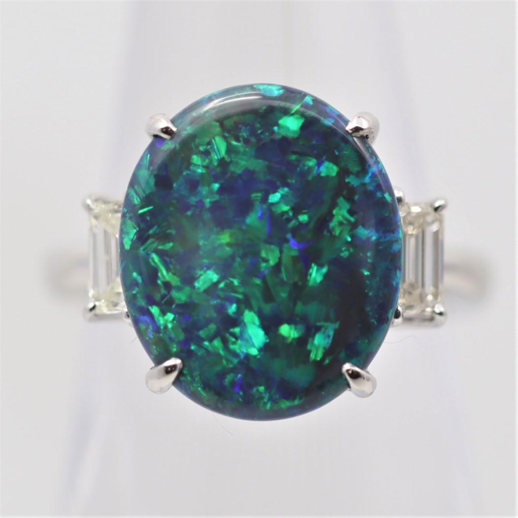 Here we have a true gem of a natural black opal from the famed Lightning Ridge deposits in Australia. It weighs 4.38 carats and has excellent play-of-color as bright flashes of greens and blues are seen across the stone over its dark black