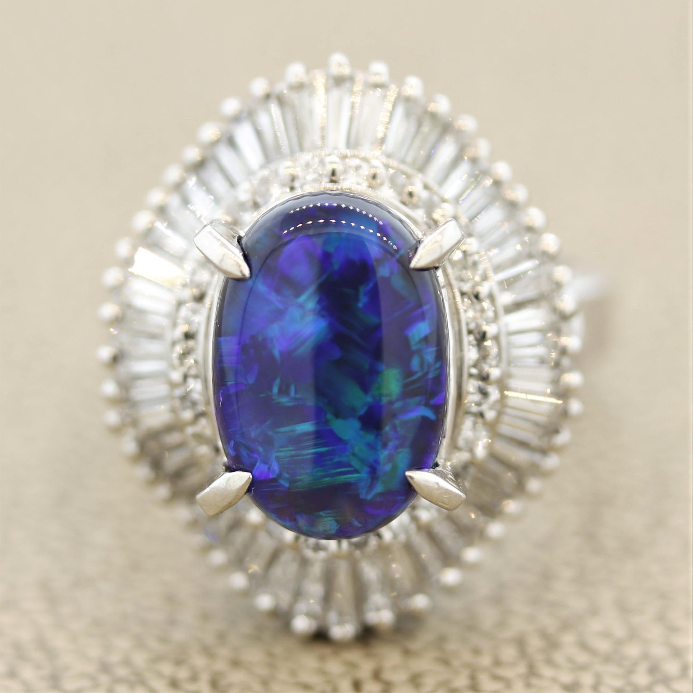 A classic Australian black opal! It weighs 3.35 carats and has great play of color as flashes of green and blue can be seen across the stone as it turns. The color pattern reminds us of the earth if one was looking at it from space. It is accented