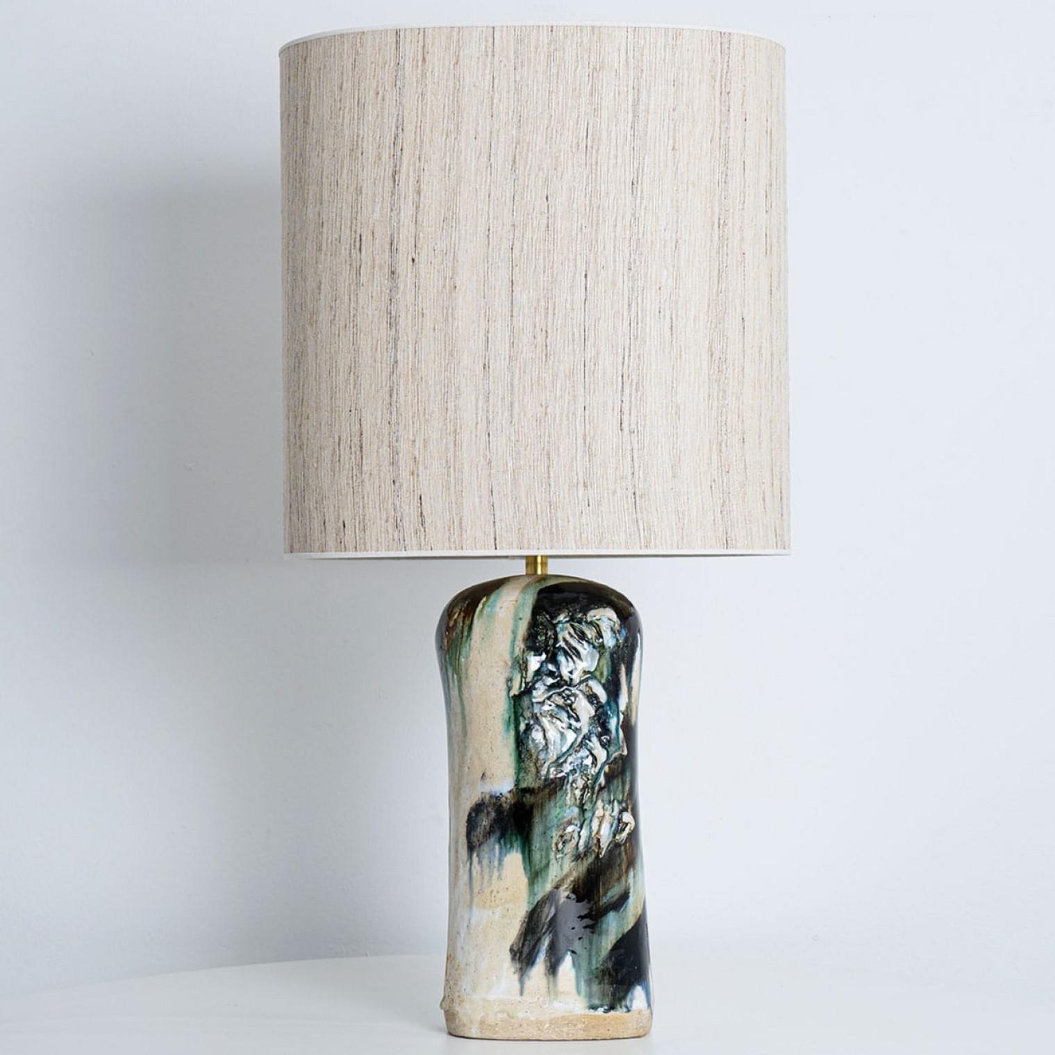 Beautiful table lamp by Jeppe Hagendorn, Denmark 1960s.

This stunning lamp has a ceramic base with earthy green and blue tones and a beautiful glaze, making it a real eye catcher and a statement piece. The lampshade is designed by Rene Houben. This