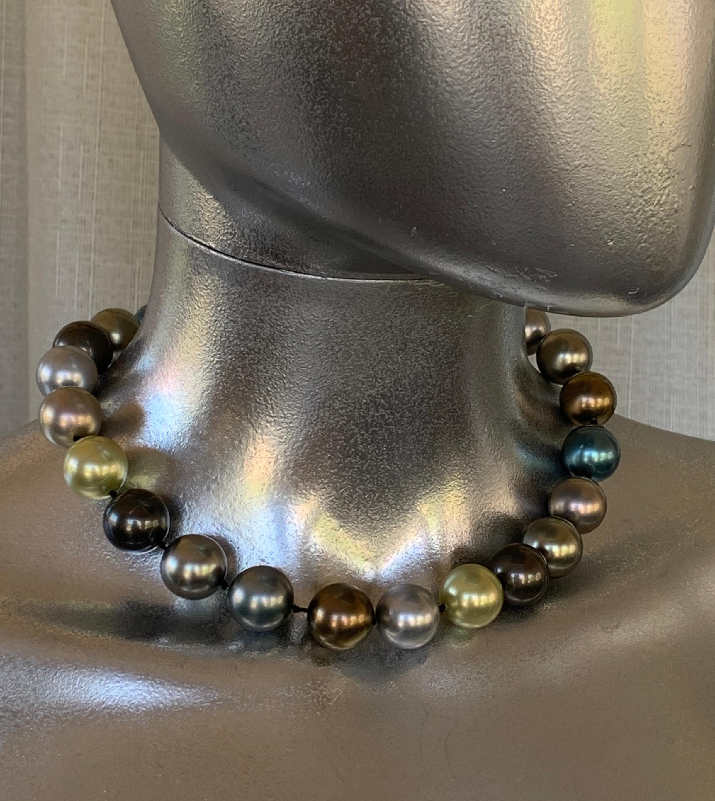 The colors of these faux pearls are just spectacular. It's a subtle, harmonious mix of celadon green, grey, blue, silver perfectly designed. the closing sphere is rhinestone pavé with hidde n screw to close. that beacomes a pavé bead which can be