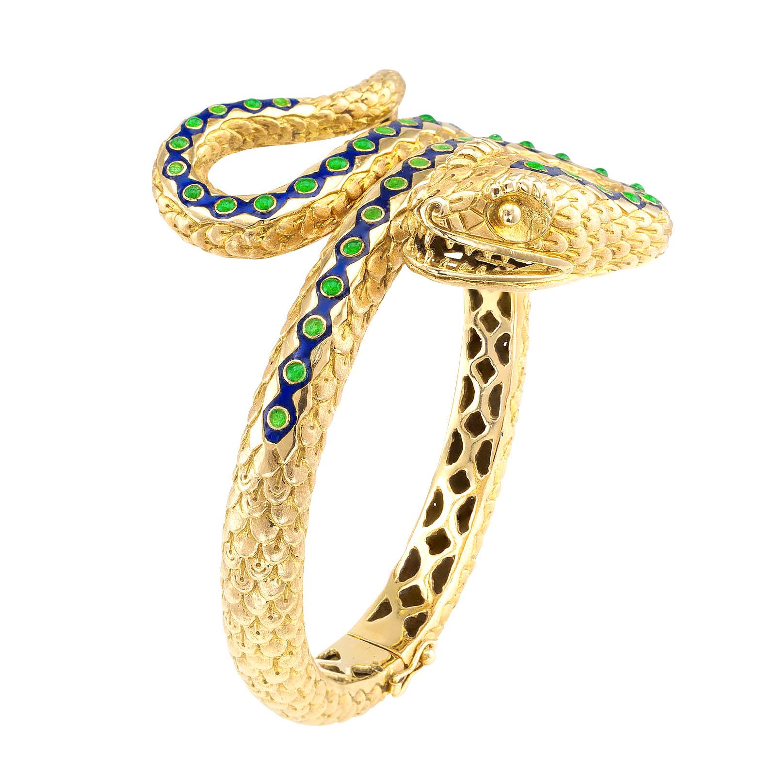 Blue and green enamel gold hinged snake bangle bracelet circa 1970.

DETAILS:
METAL: 18-karat yellow gold decorated with blue and green enamel accents accompanied by reptile scale motifs.

MEASUREMENTS: approximately 2” (5.0 cm) wide at the top and