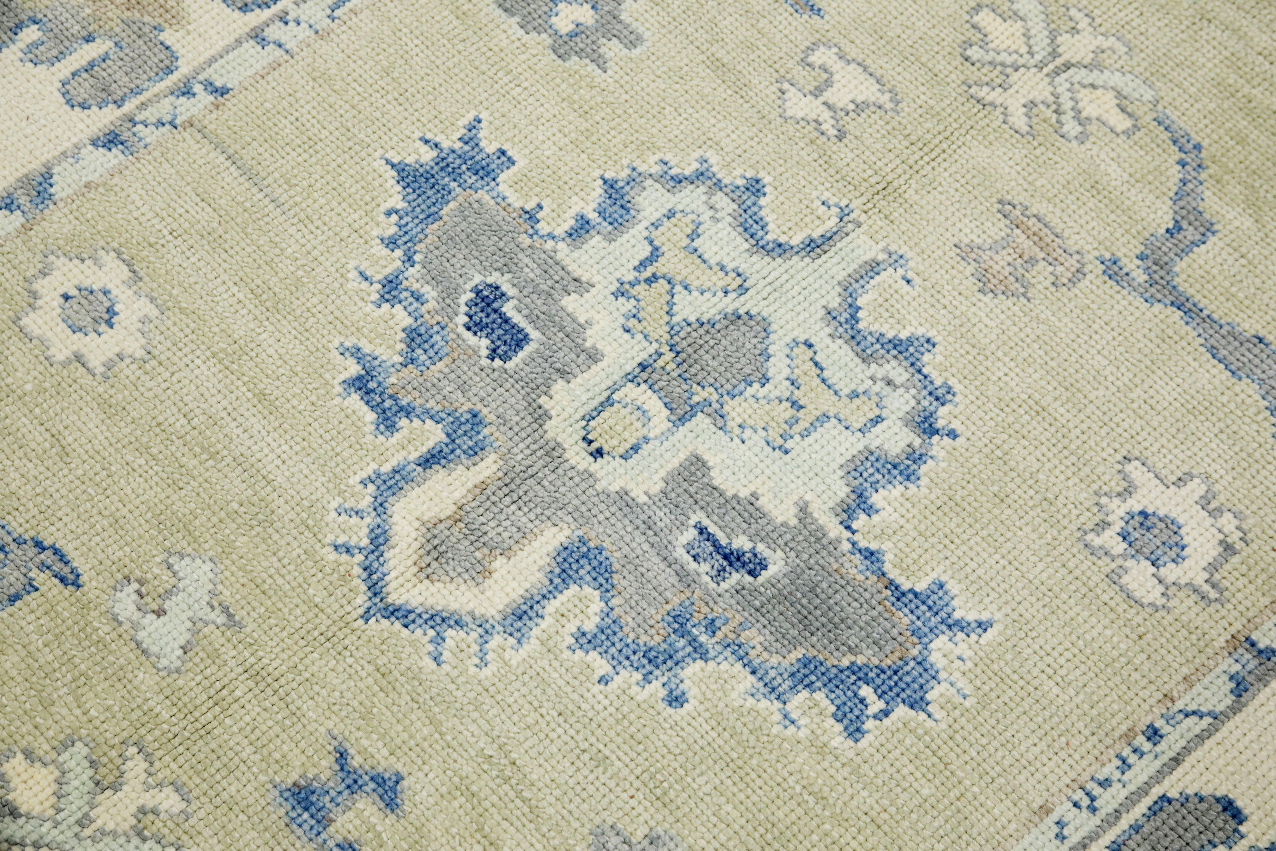 This modern Turkish Oushak rug is a stunning piece of art that has been handwoven using traditional techniques by skilled artisans. The rug features intricate patterns and a soft color palette that is achieved through the use of natural vegetable