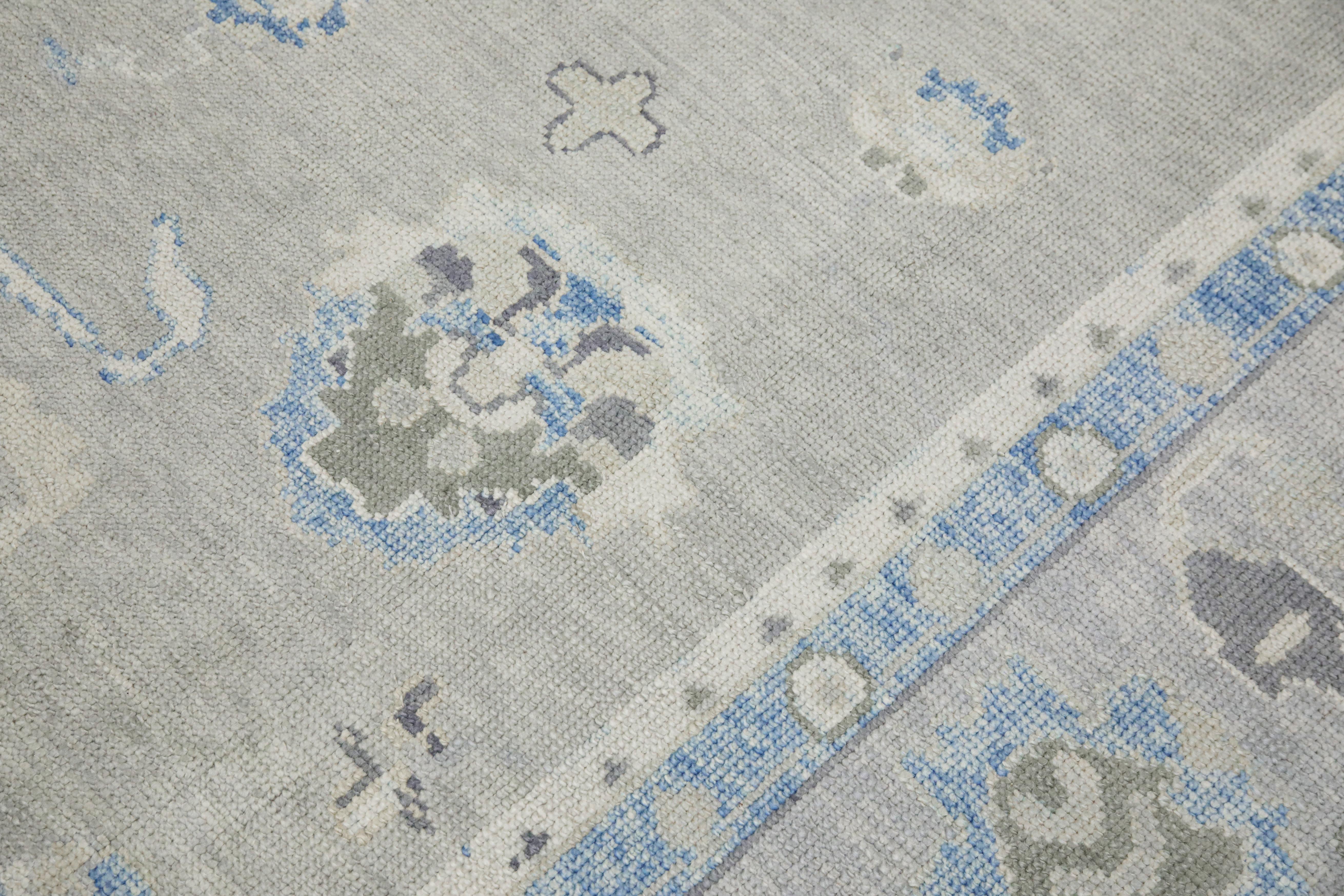 This modern Turkish Oushak rug is a stunning piece of art that has been handwoven using traditional techniques by skilled artisans. The rug features intricate patterns and a soft color palette that is achieved through the use of natural vegetable