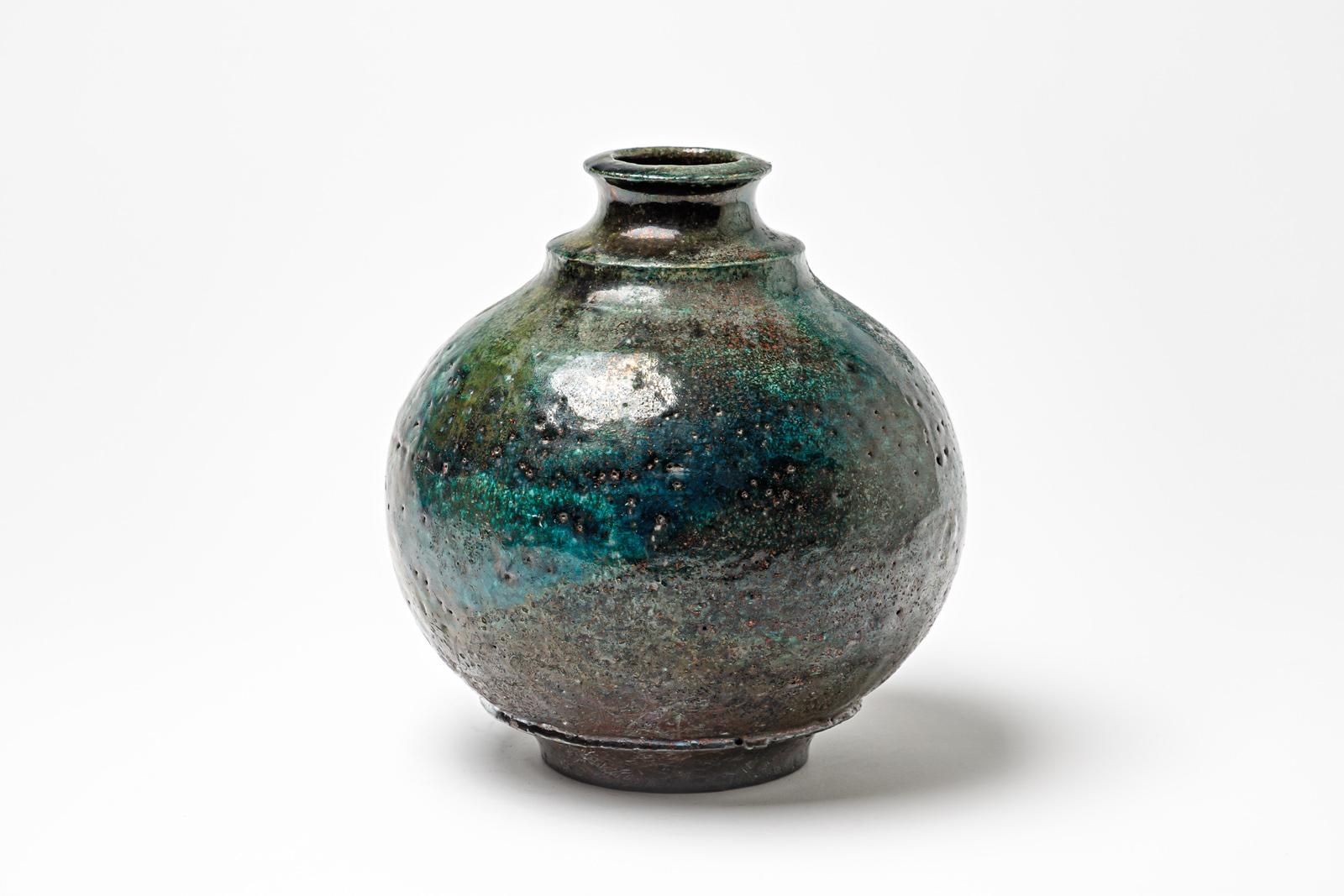 Blue/green glazed ceramic vase by Gisèle Buthod Garçon. 
Raku fired. Artist monogram under the base. Circa 1980-1990. 
H : 8.7’ x 7.1’ inches.