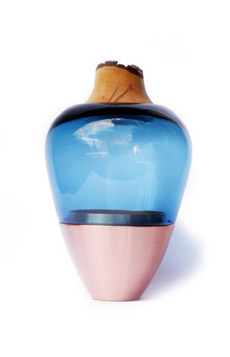 Blue Green India Vessel I, Pia Wüstenberg
Dimensions: D 20 x H 38
Materials: glass, wood, metal
Available in other metal: copper, brass

Handmade in Europe, by individual craftsmen: handblown glass (Czech Republic), hand spun metal, (England),