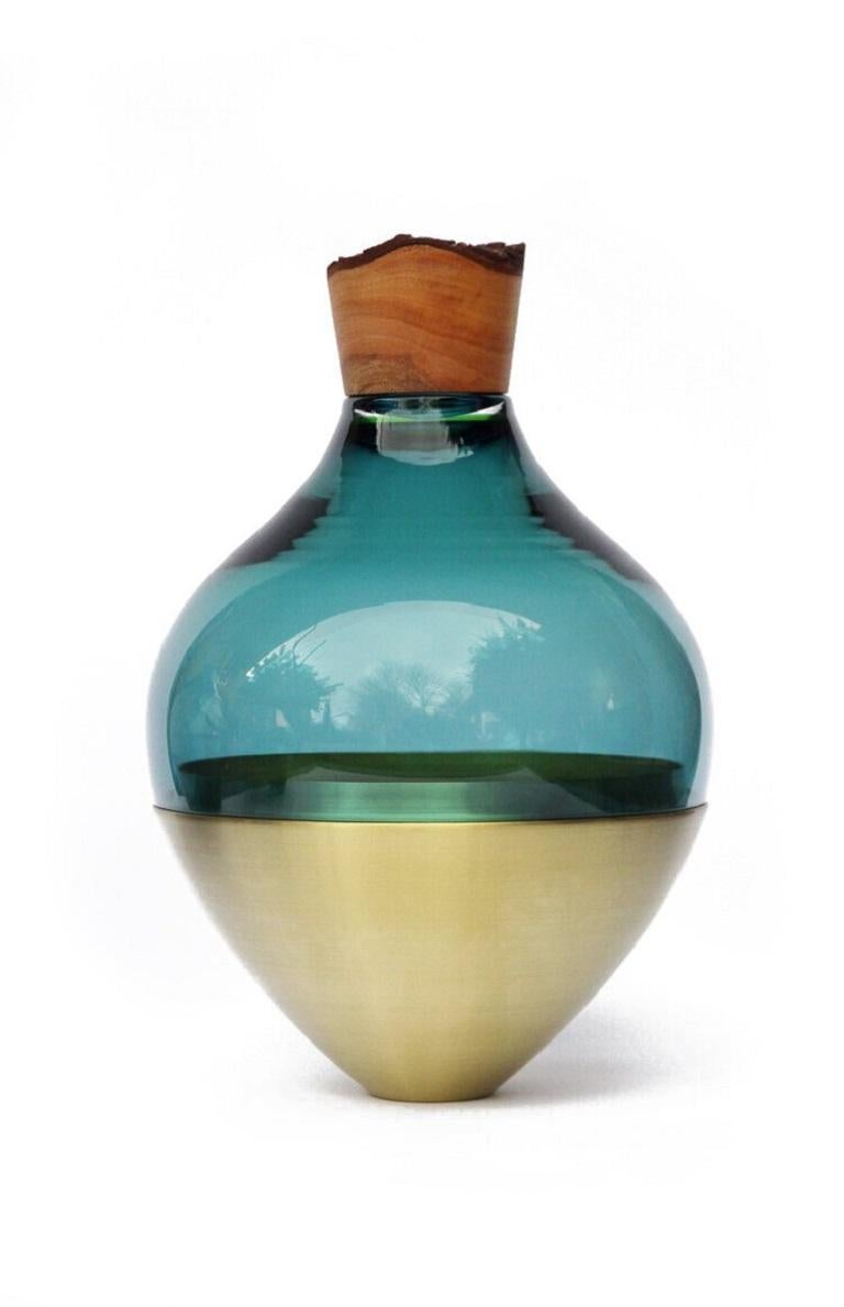 Blue Green India vessel II, Pia Wüstenberg
Dimensions: D 20 x H 38.
Materials: glass, wood, metal.
Available in other metals: brass, copper.

Handmade in Europe, by individual craftsmen: handblown glass (Czech Republic), hand spun metal,