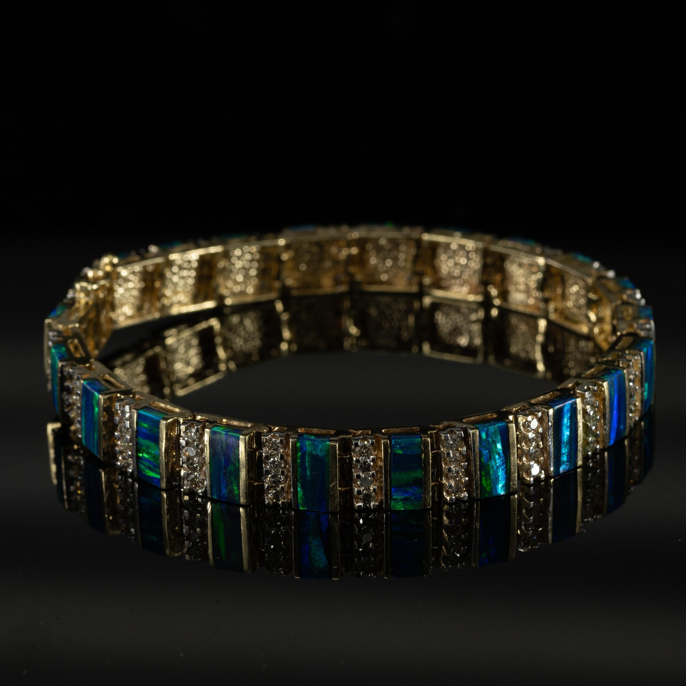 This luxurious bracelet features exquisite bar-cut opals set in 14k yellow gold, each stone radiating a mesmerizing play of colors. The opals are elegantly accented with sparkling diamonds, adding a touch of brilliance to the design. Crafted with