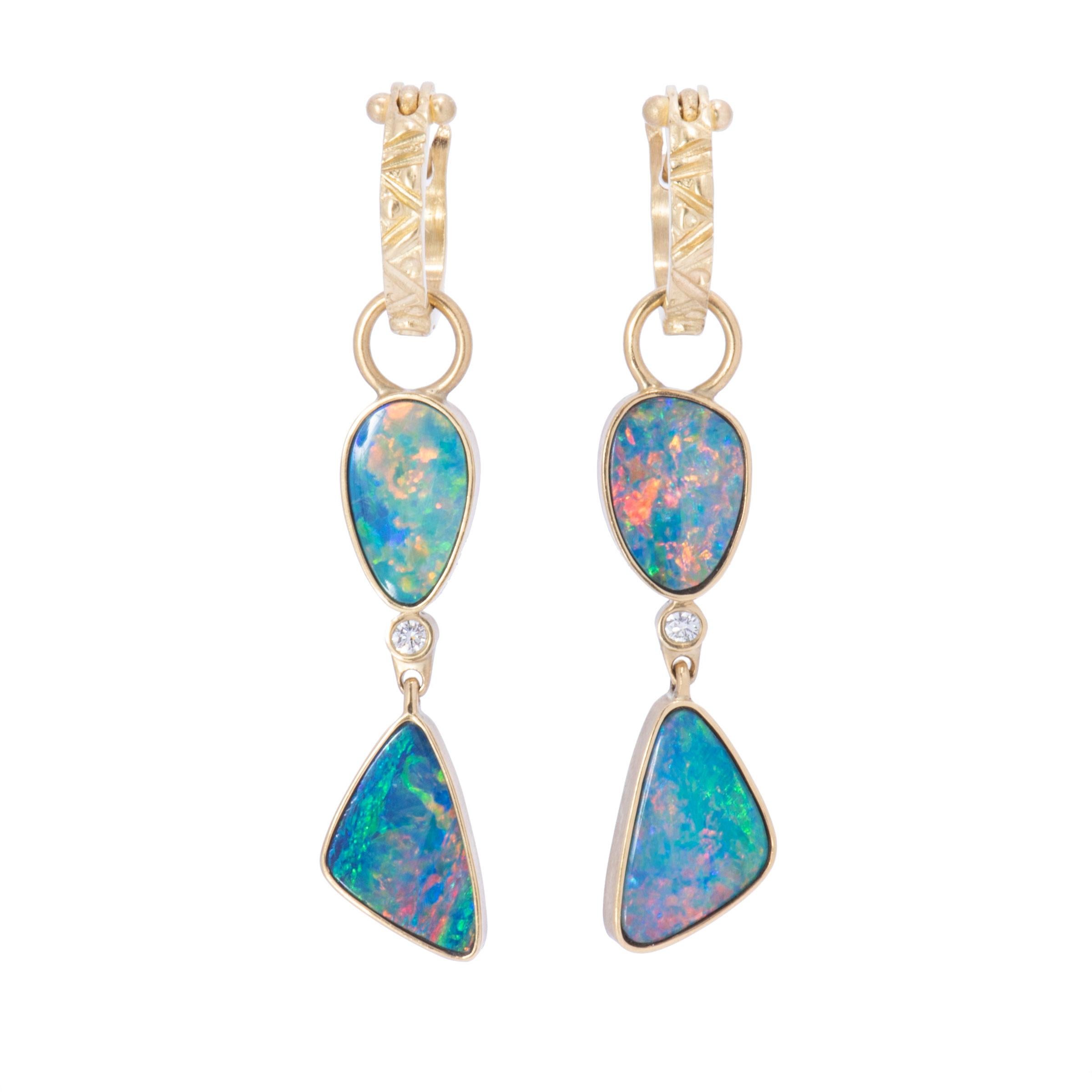 Dreamy blue green Boulder Opals flash with orange and yellow fire in two-tiered drop earrings. Enhanced with .08tcw white diamonds, these two-tiered drop earrings hang from 18 karat gold small galaxy hoops in 18 karat gold. Measuring 1.75