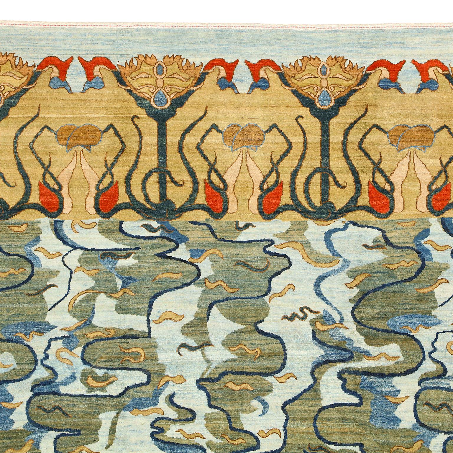 From Orley Shabahang’s Art Nouveau collection, this contemporary 6' x 9' Persian carpet, measuring exactly 5’11” x 9’2”, possesses vivid blues, greens, golds, and oranges, all achieved using organic dyes. Traditionally, rug weaving has always taken