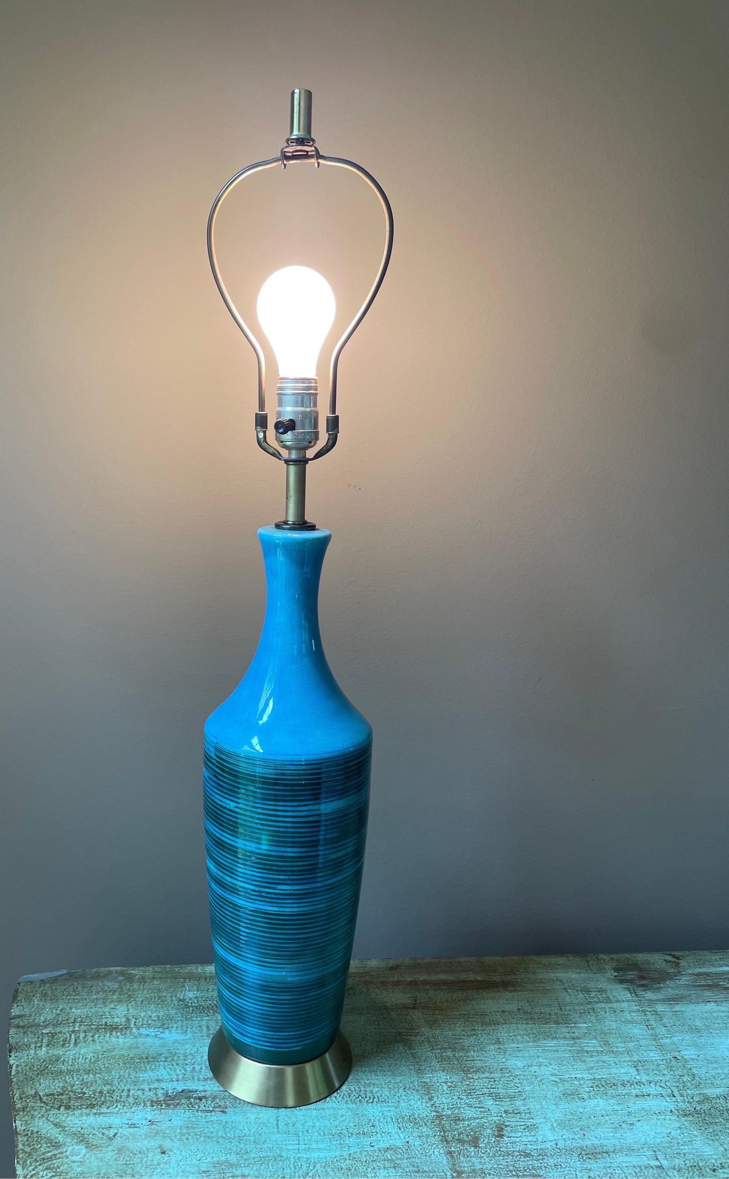Colorful and stylish, this midcentury style ceramic table lamp is a great way to add a pop of color and functionality to any room that needs a pick-me-up! The best thing about this lamp is the color - turquoise base with right blue/green ribs