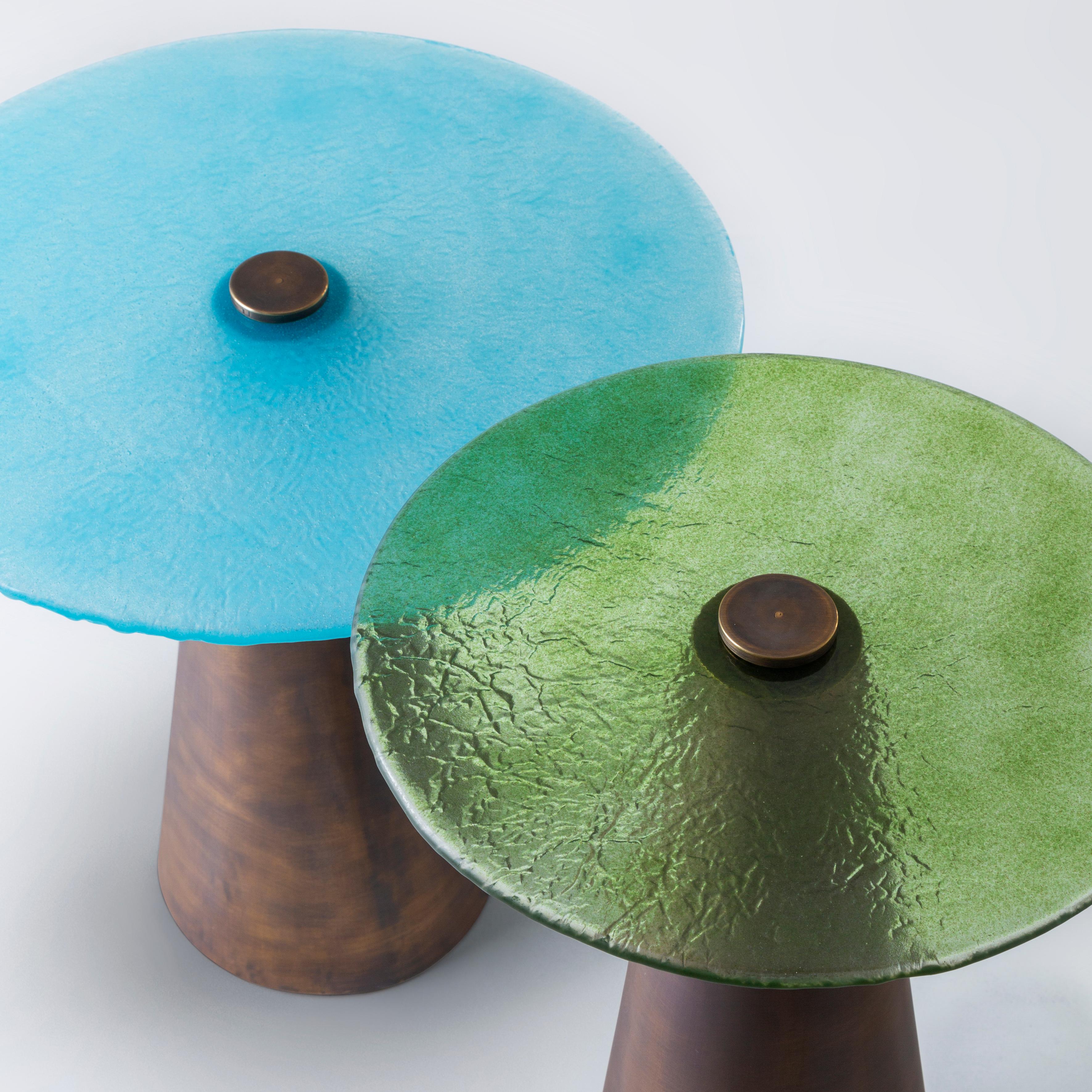 Blue & Green Set of Accent Tables with Hand-Blown Glass Mounted on Brass Cones. 
Fun, elegant and versatile. This duo made of brass base and hand-blown craft glass are a joy to look at. The turquoise – apple green mix is an all time classic, but