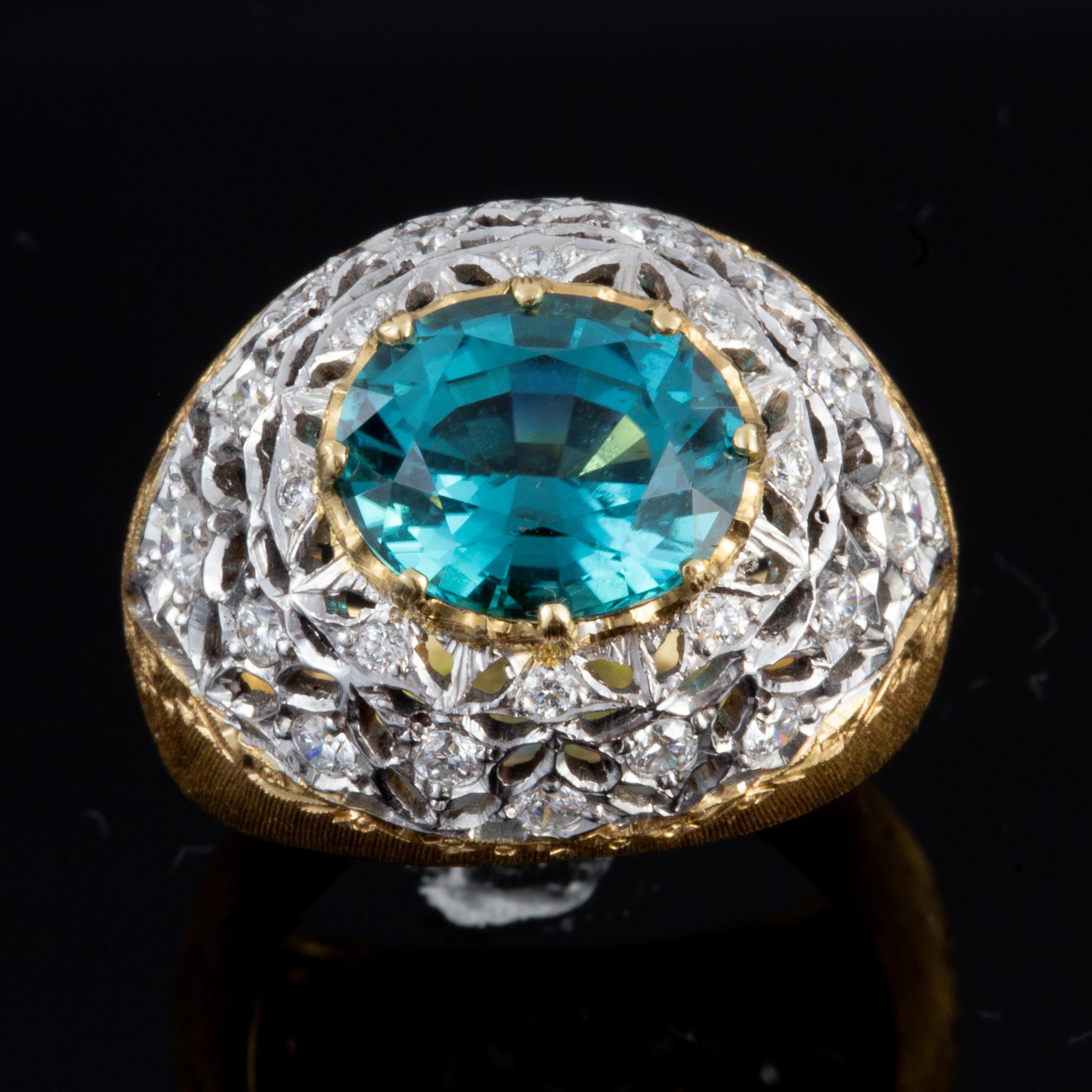 Handcrafted in Italy in an old world Florentine style, this exquisite blue green Tourmaline & Diamond ring is set in two tone 18 kt Gold and makes for a truly beautiful statement piece.  Handcrafted by a small family run studio in Florence, Italy