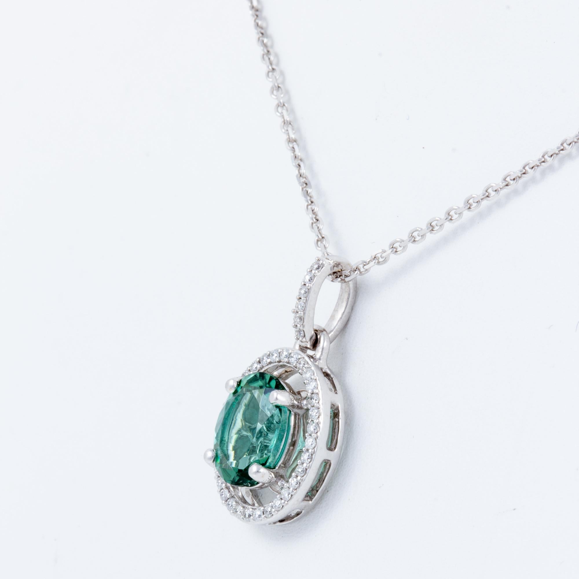 1.26ct. blue green tourmaline set in 14kt white gold with .13 ctw diamonds on a 16