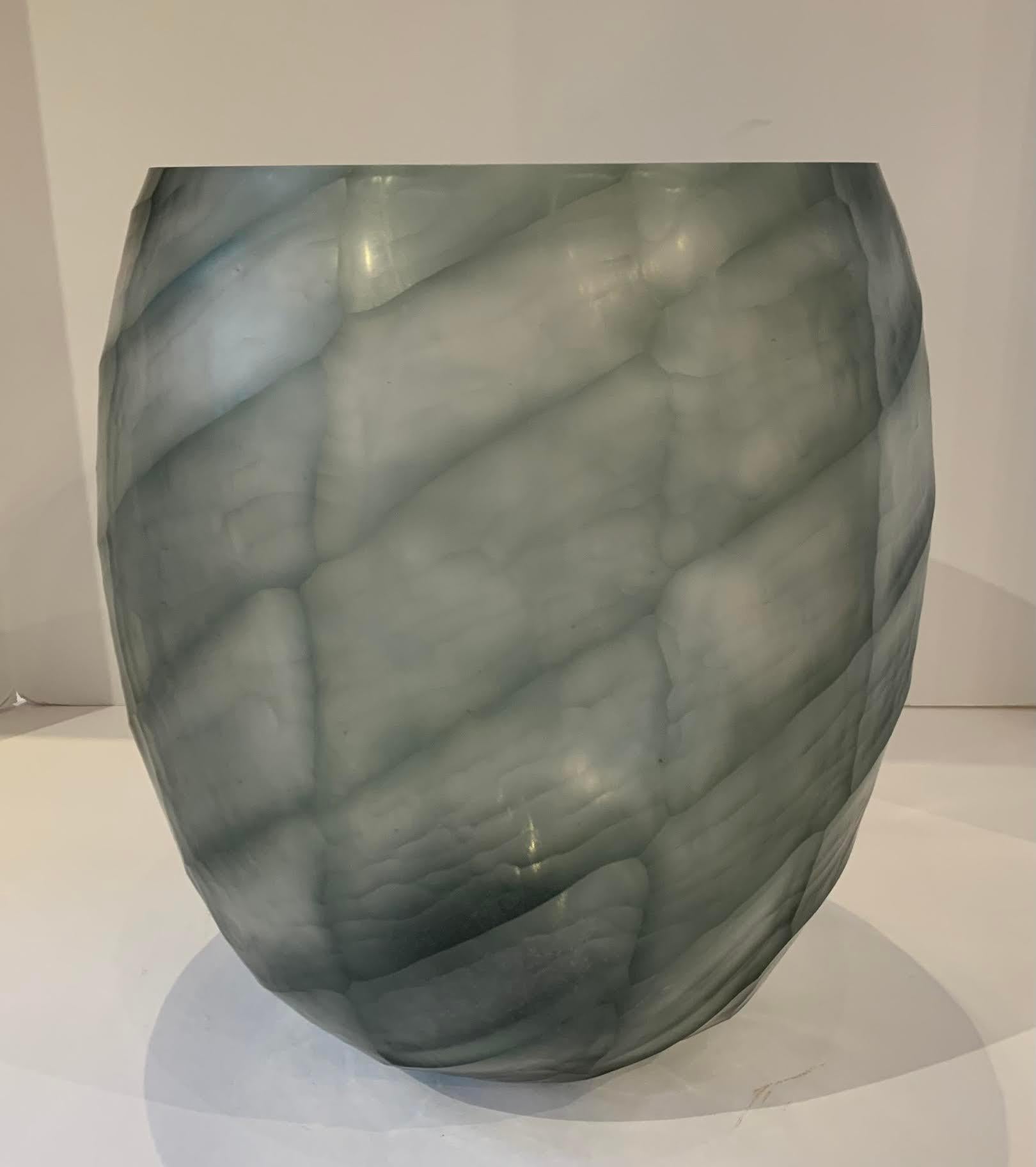 Contemporary Romanian glass vase with cut criss cross pattern design.
The design is transparent and appears to change color with the light.
