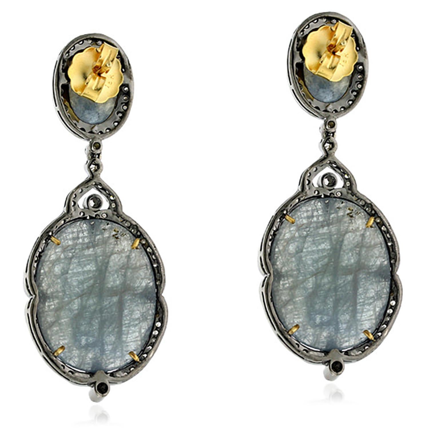 Pretty and unique looking this blue grey slice sapphire drop earring in silver with gold push and post is ornated with pave diamonds around making it wearable with denims for semi formal look.

Closure: Push