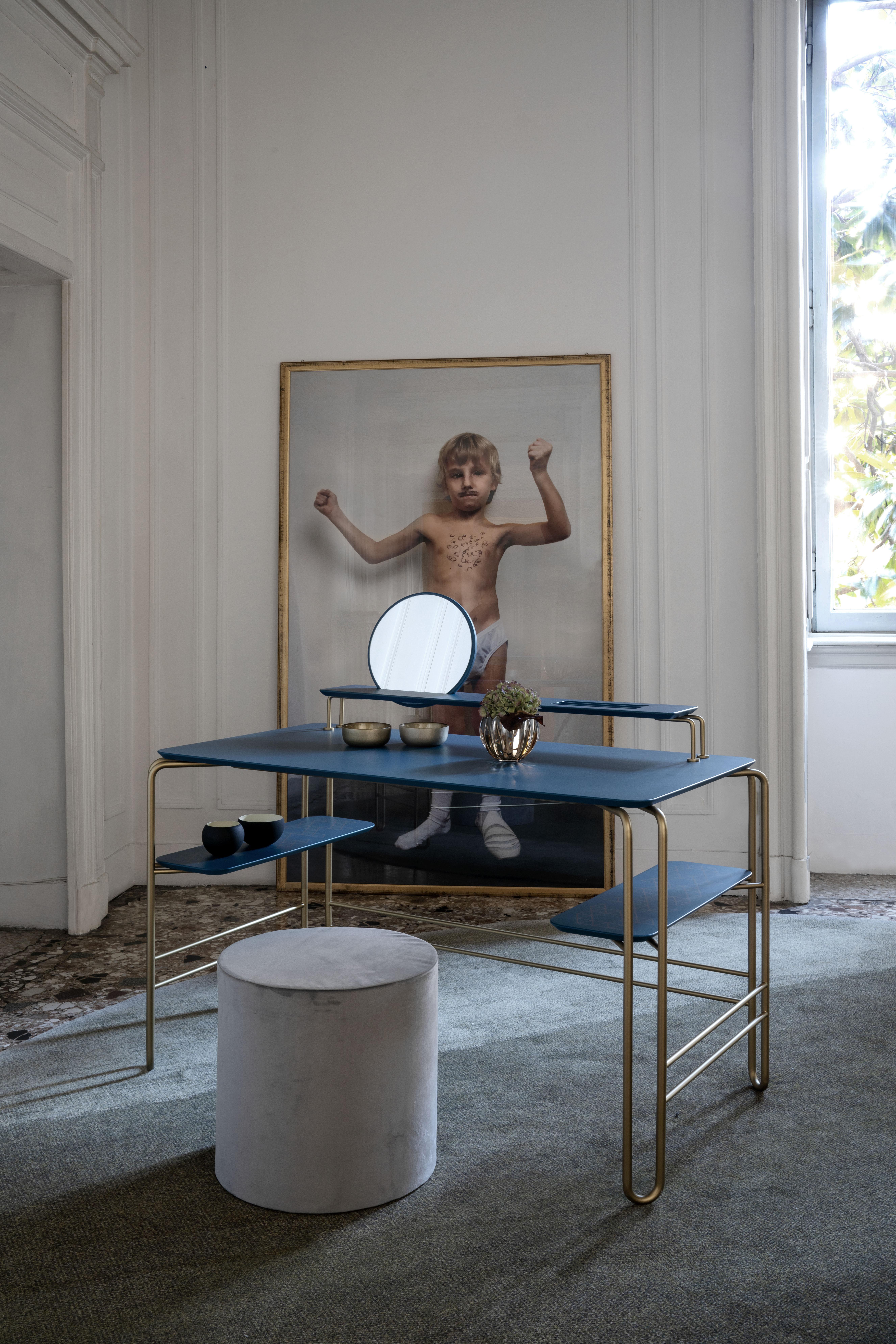Blue grimilde console table by Mentemano
Dimensions: W 120 x D 65 x H 88 cm
Materials: Steel, wood, mirror 
Other colors available.

Console desk made of bended coated steel defined by clear and minimal lines with lacquered wood shelves. The