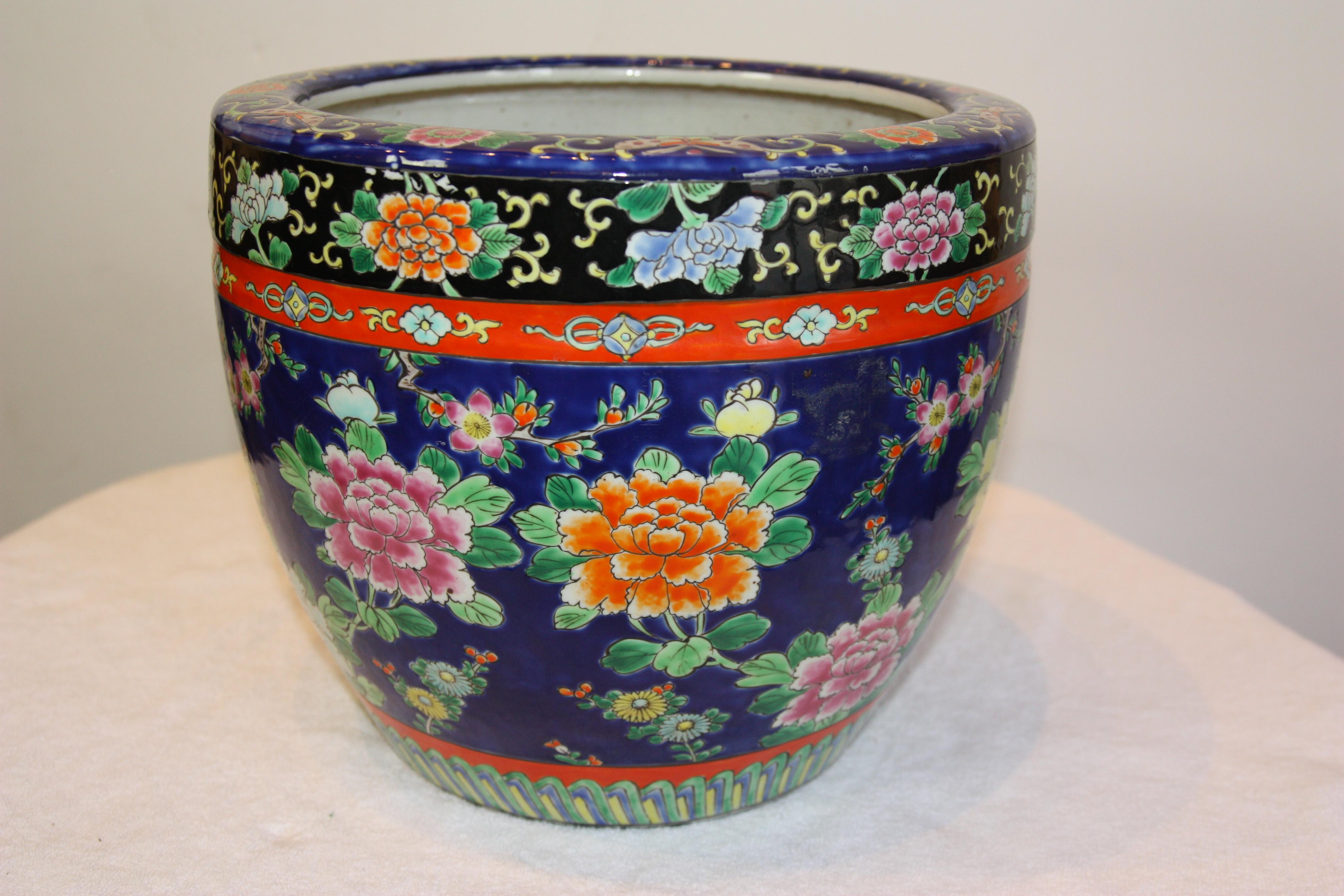 Dark blue, hand-painted, Asian jardinière with flowers and design bands.