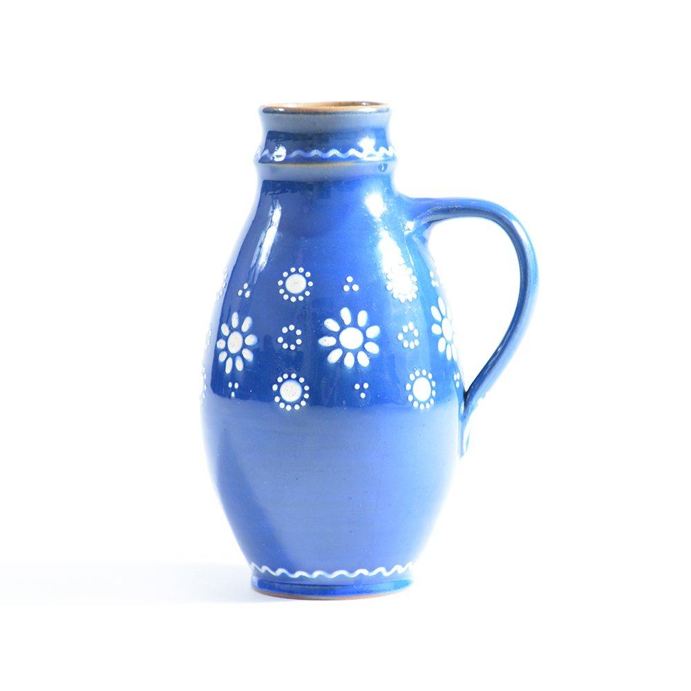 Beautiful blue ceramic jug in national folk ornaments in white color. Handmade in Czechoslovakia in 1950s. The jug shows off a typical folk pattern and colors. Original condition. The jug is made of clay, and fired blue glaze. Very strong Material.