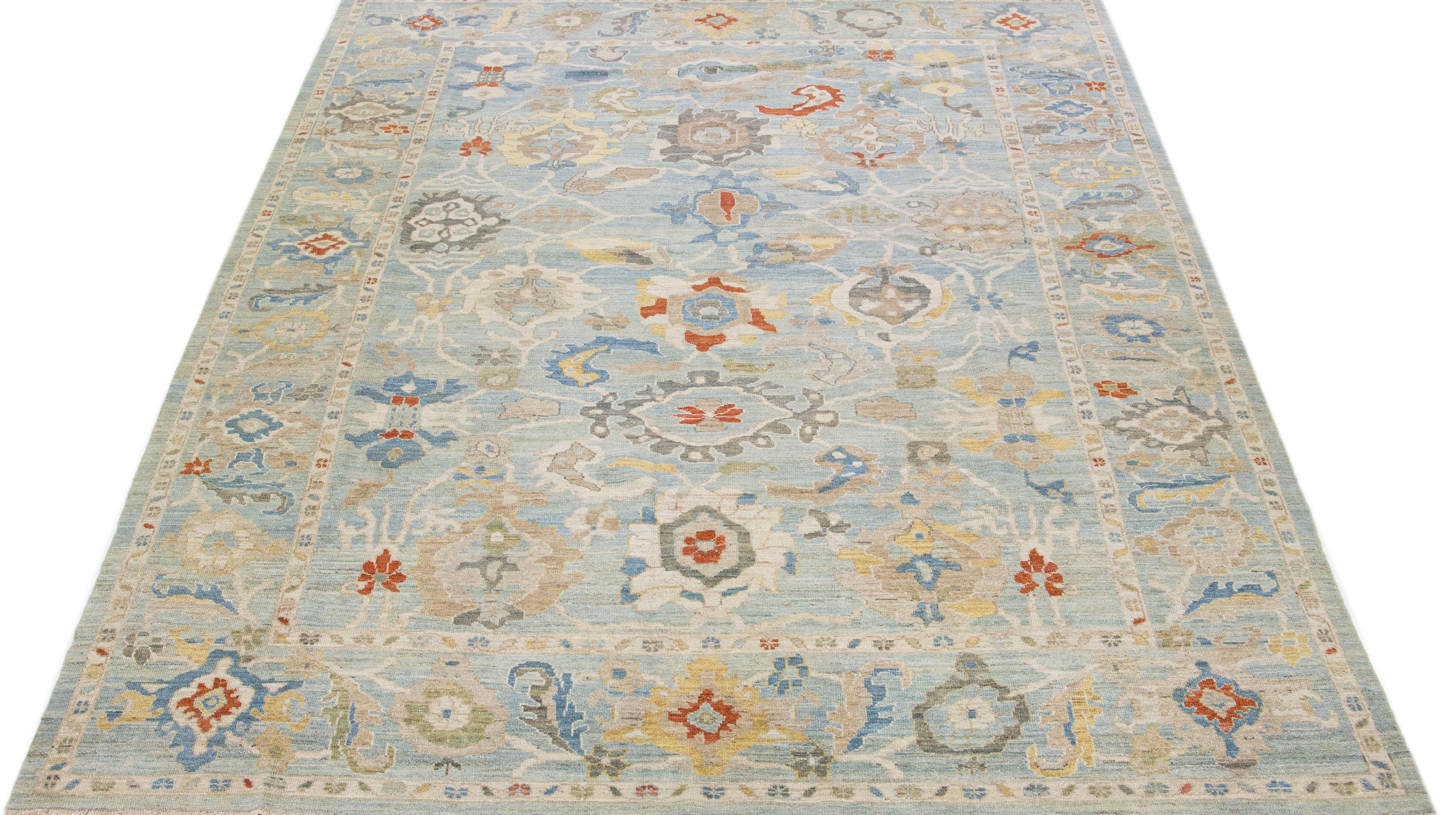Beautiful modern Sultanabad hand-knotted wool rug with a blue color field. This rug has a designed frame with beige, yellow, and rust accents in a gorgeous all-over floral motif.

This rug measures: 10'2