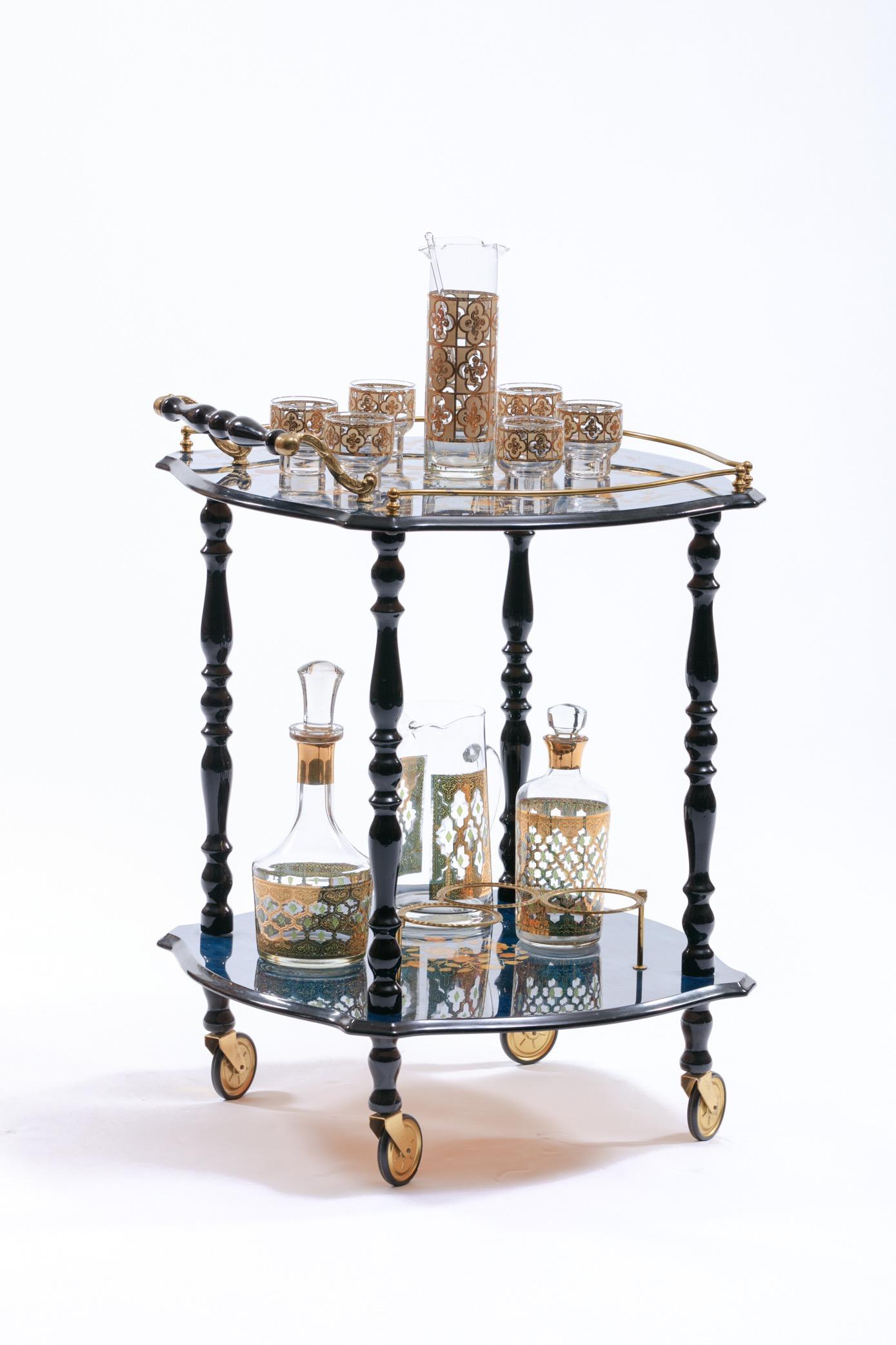 The most darling little Italian bar cart, its curvy square shape is so unique. Italian 1960s marquetry inlay bar cart with brass wheels and hardware. Floral design inlaid in top and bottom shelf, with brass gallery. Similar hardware and form to Aldo