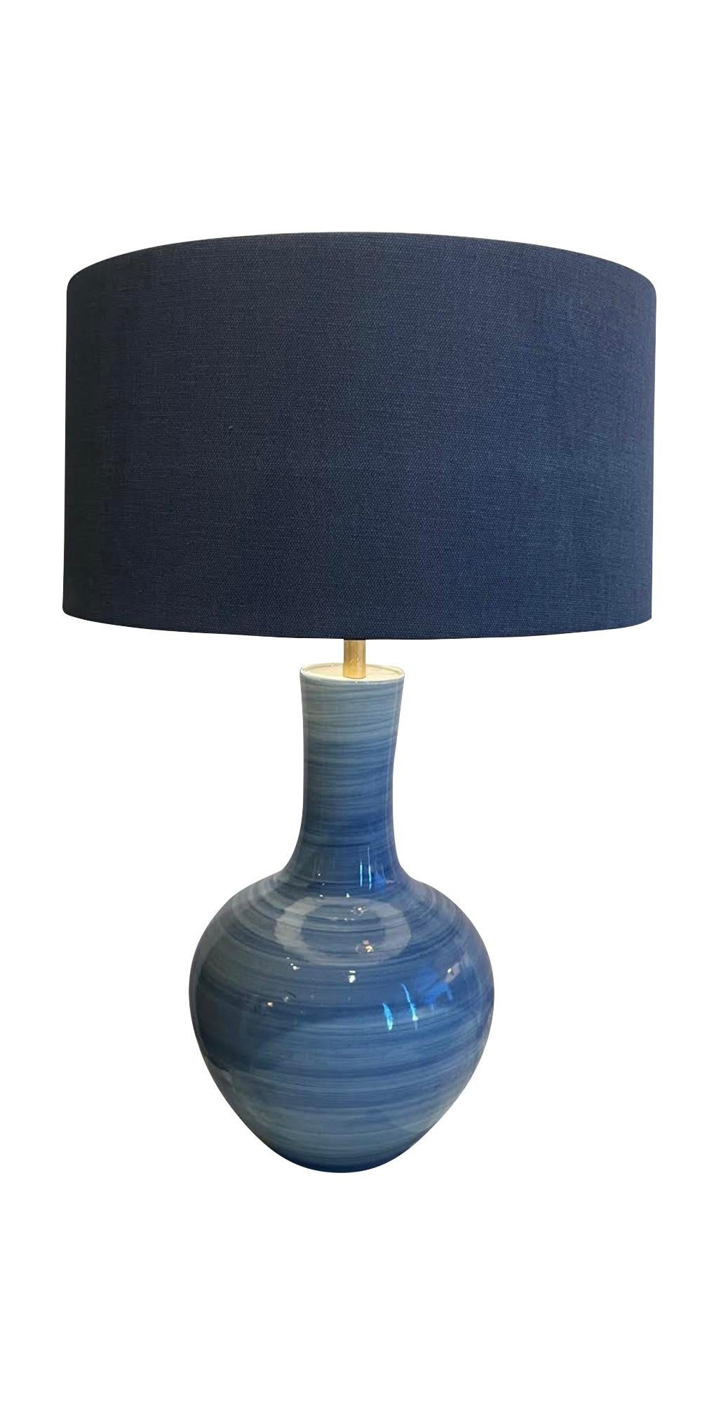 Contemporary Chinese pair blue horizontal striated design lamps.
Tube neck shaped design.
White boucle shades included.
Base diameter measures 9
