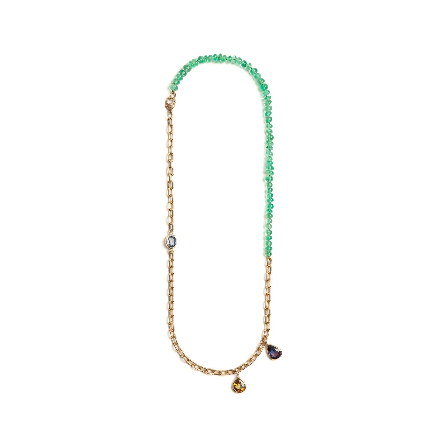 Hand-knotted fine Colombian emerald beads accented with 3 sapphire gems and set on an 18k yellow gold elongated cable chain. 
The color and size of the emeralds paired with the bicolor sapphire make for a truly stunning necklace. 

18