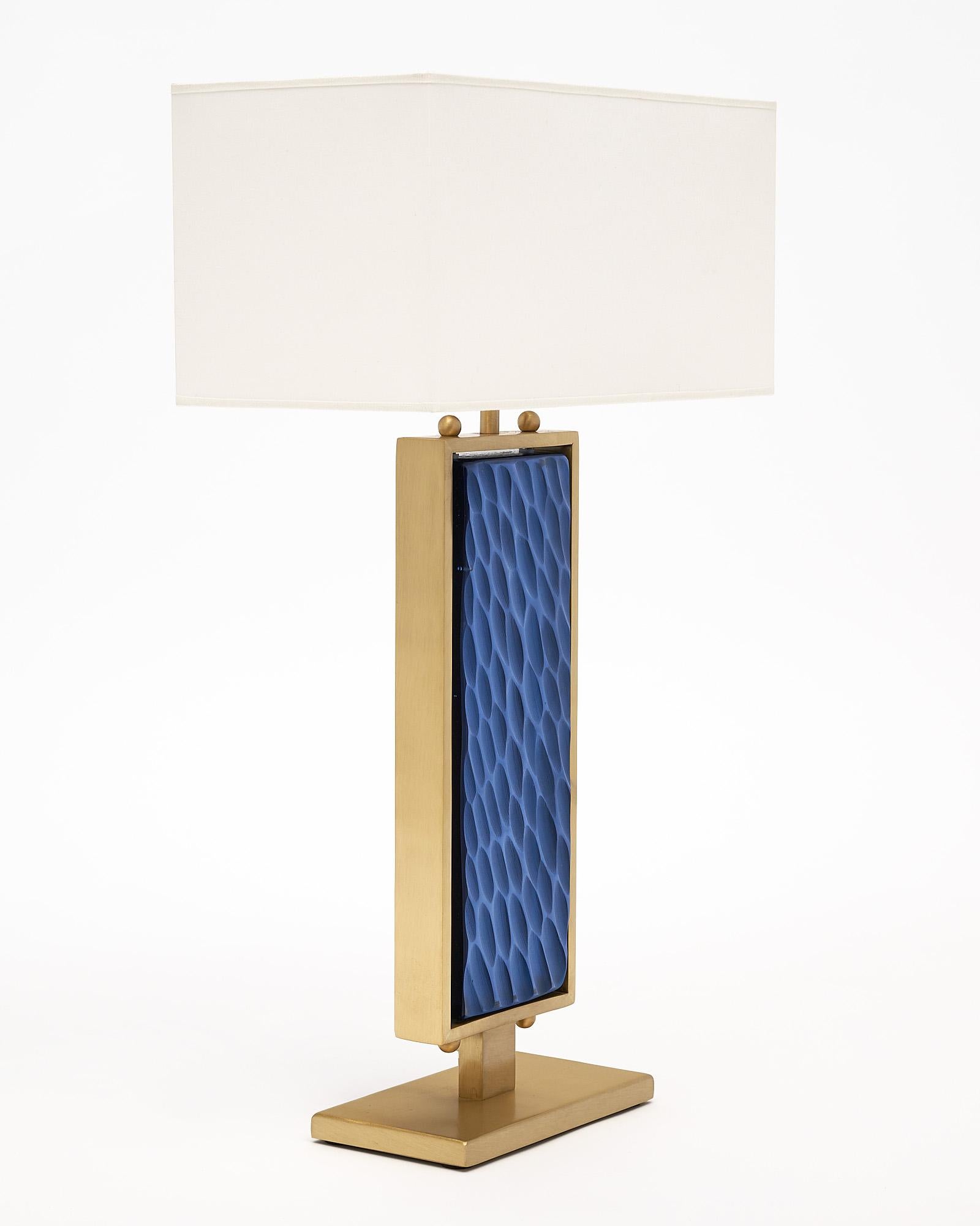 Murano glass in a blue hue and solid brass make these beautiful table lamps so stunning. With rectangular bases, the opaque blue colored glass is surrounded by brass, and light is able to pass through the glass in remarkable ways. The glass is