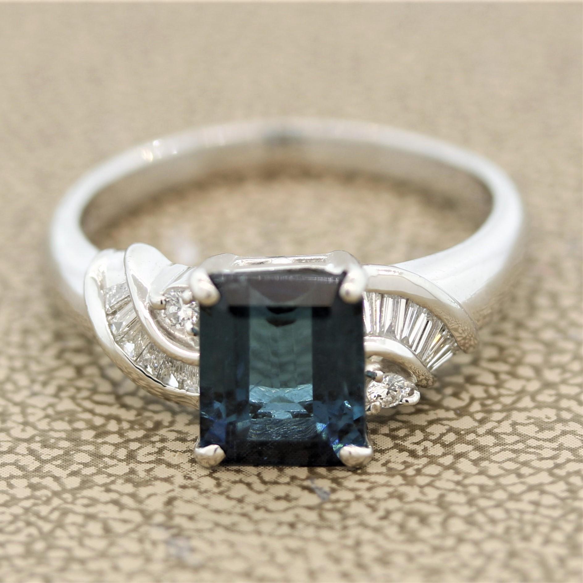 A fine indicolite tourmaline takes center stage of this cute and stylish ring. It weighs 2.55 carats and has a deep rich blue color giving it the trade name “indicolite.” It is accented by 0.22 carats of round brilliant and baguette cut diamonds