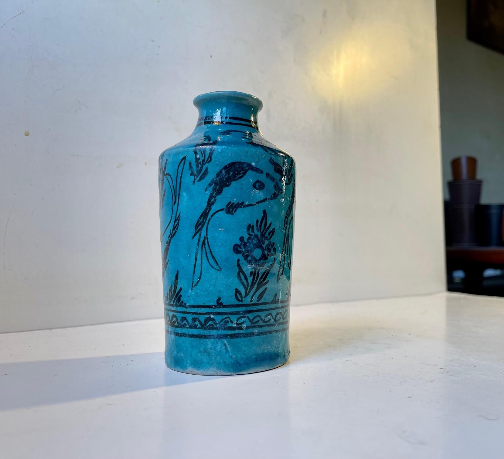 A blue glazed stoneware vase hand-decorated with fishes and flowers. It has no markings but we suspect it might have been made by Italian ceramist Guido Gambone during the 1940s or early 50s. That being said it is sold as in the manner of GG and is