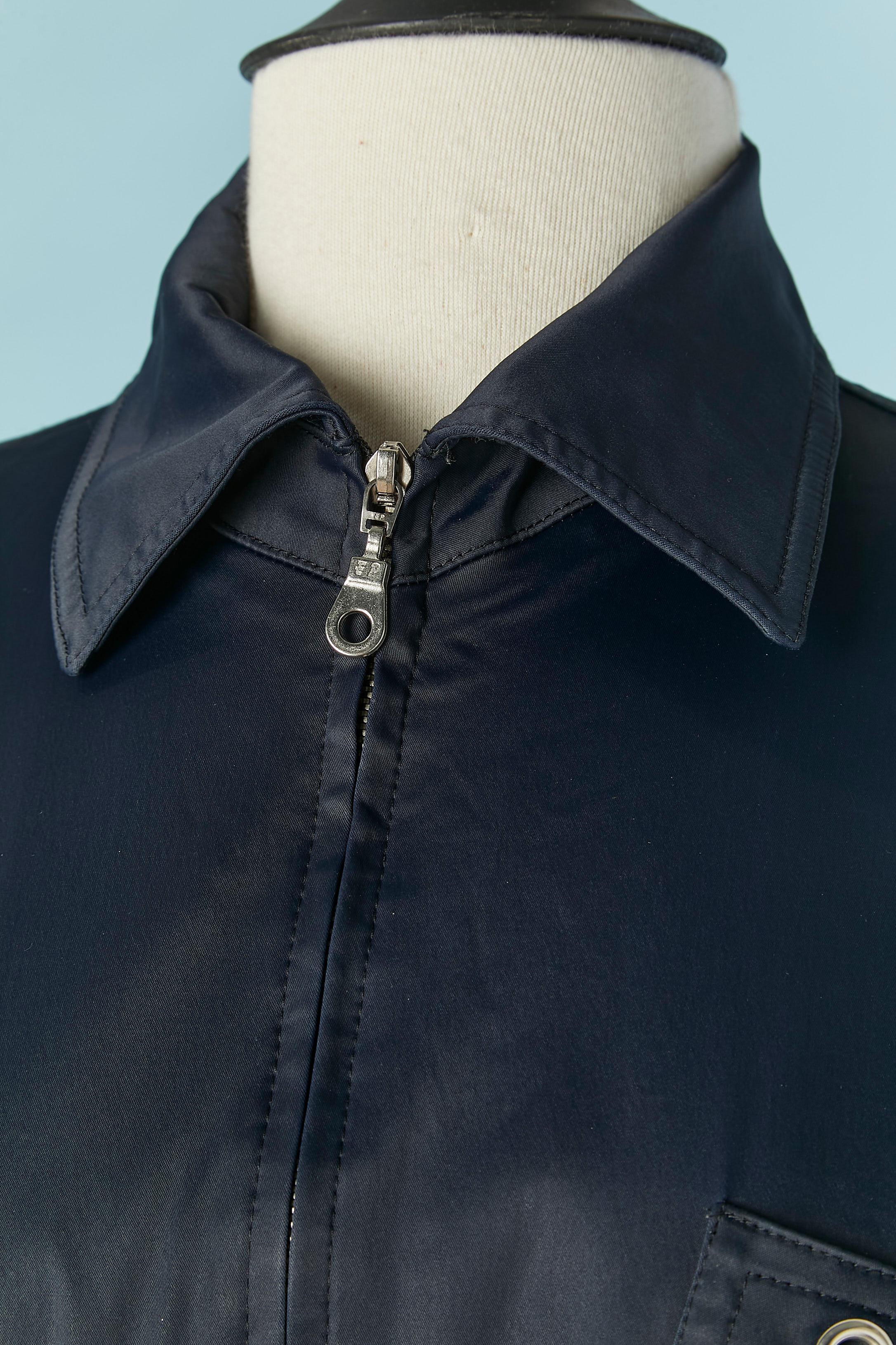 Blue jacket with rope belt and eyelet . 
Fabric composition: 71% acetate, 23% nylon, 6% rubber. Zip closure on the middle front . 4 pockets on the front. Box-pleat on the middle back. 
SIZE M 