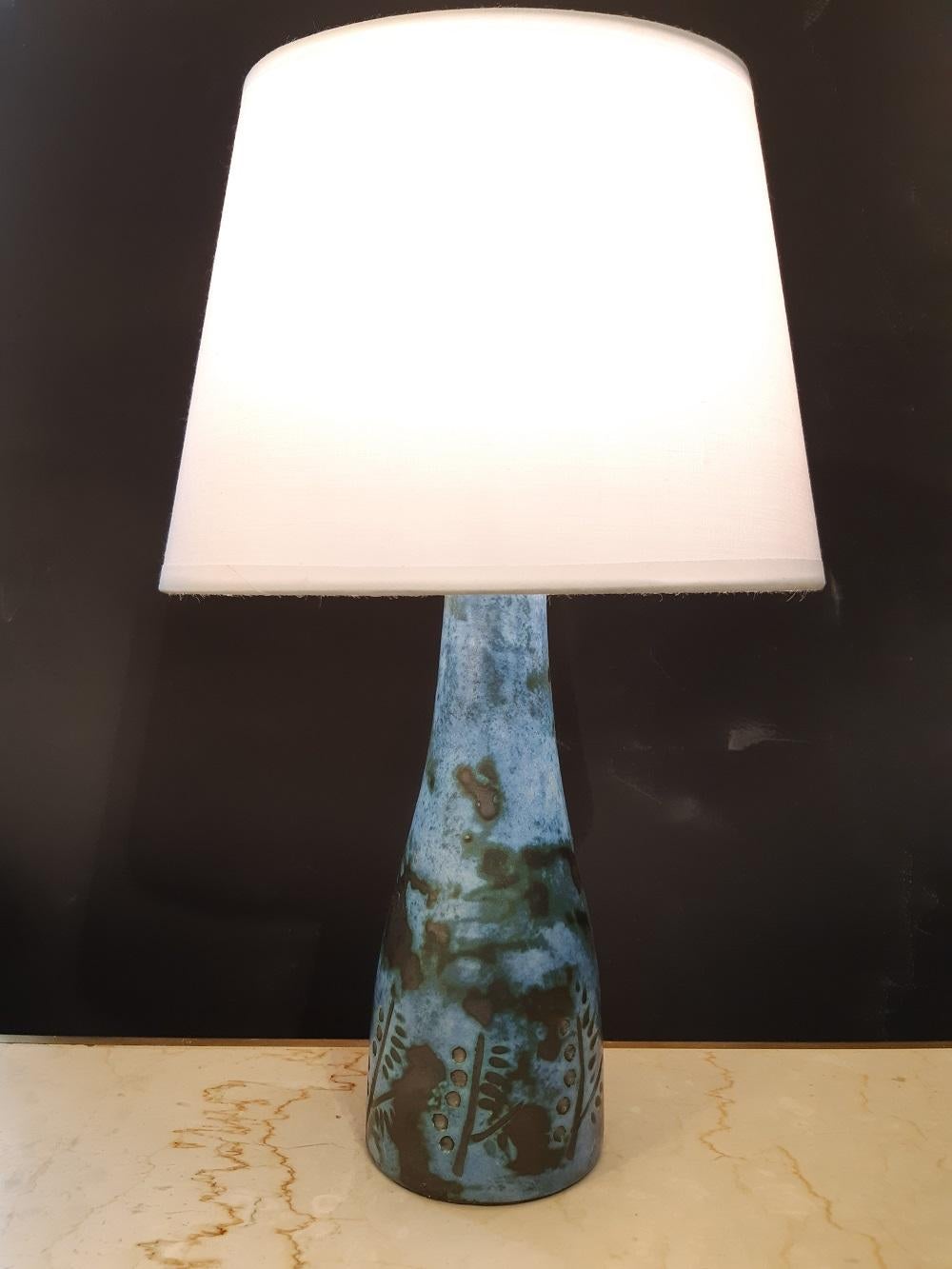 Blue Jacques Blin ceramic lamp France midcentury, 1950

Jacques Blin ceramic lamp, signed under the base.
Electrified with a new lampshade provided.
Measures: Socket height 20cm, height with lampshade 33cm, base diameter 8cm.

Excellent