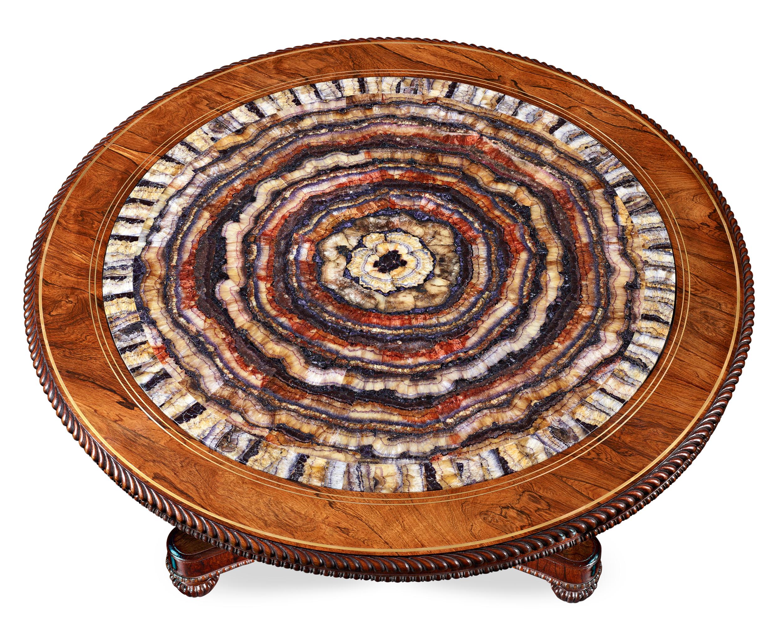 A one-of-a-kind masterpiece, this impressive table is among the finest pieces of Blue John furniture ever crafted. The star of the table is undoubtedly the monumental slab of Derbyshire Blue John set at its center. One of the most important examples