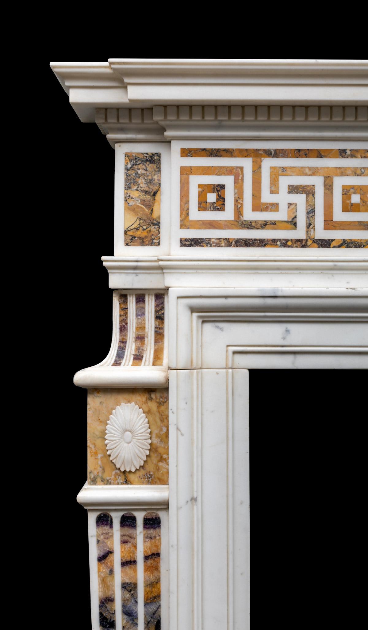 A magnificent antique statuary marble chimneypiece with semi-precious Blue-John and Sienna marble inlays. The statuary marble centre tablet has a large inlaid oval panel of 'Millers vein Blue John'. This is flanked by frieze panels, inlaid with