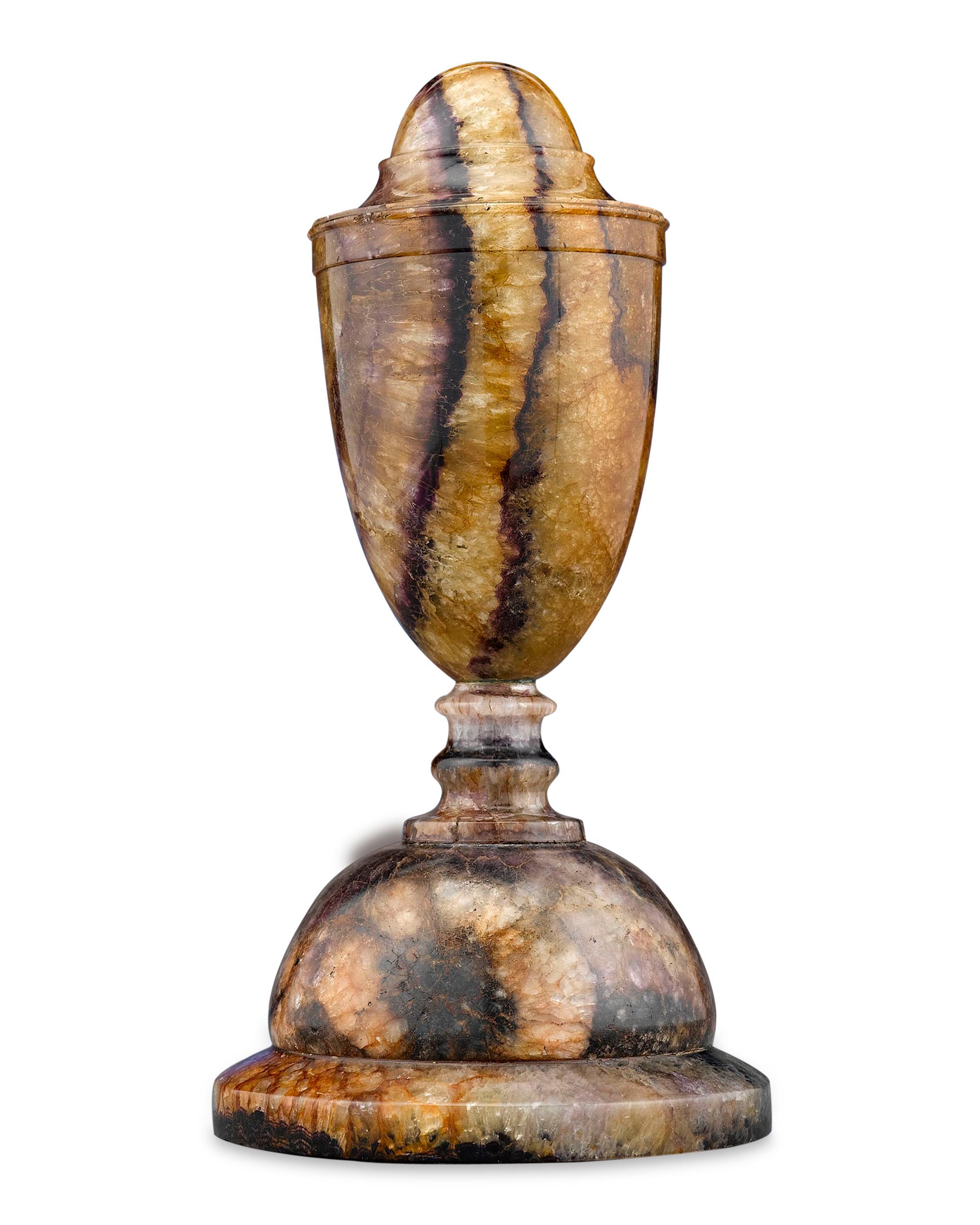This beautiful ornamental urn is carved of rare Blue John Derbyshire spar, taken from the now-extinct Blue John Cavern in Derbyshire, England. Crafted in a classically-inspired shape, this closed urn evokes the elegance of the Georgian period. Since