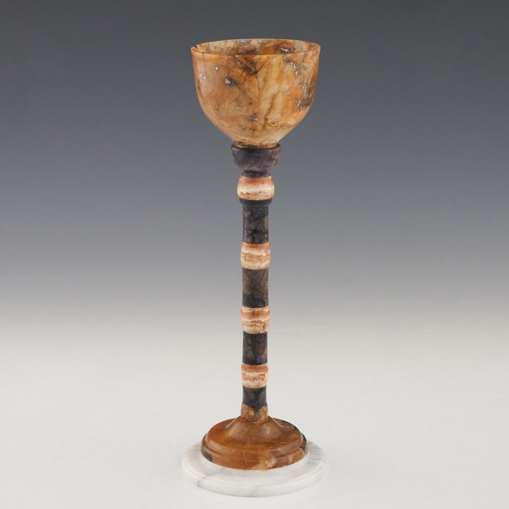 Heading : Blue John chalice
Origin : Derbyshire, England
Colour : Blue, cream, pale brown, and white
Bowl : Cup shaped made of 12 Vein Blue John
Stem : Banded baryte knops with blue john set between.
Foot : White carrara marble  
Size :  21.5cm