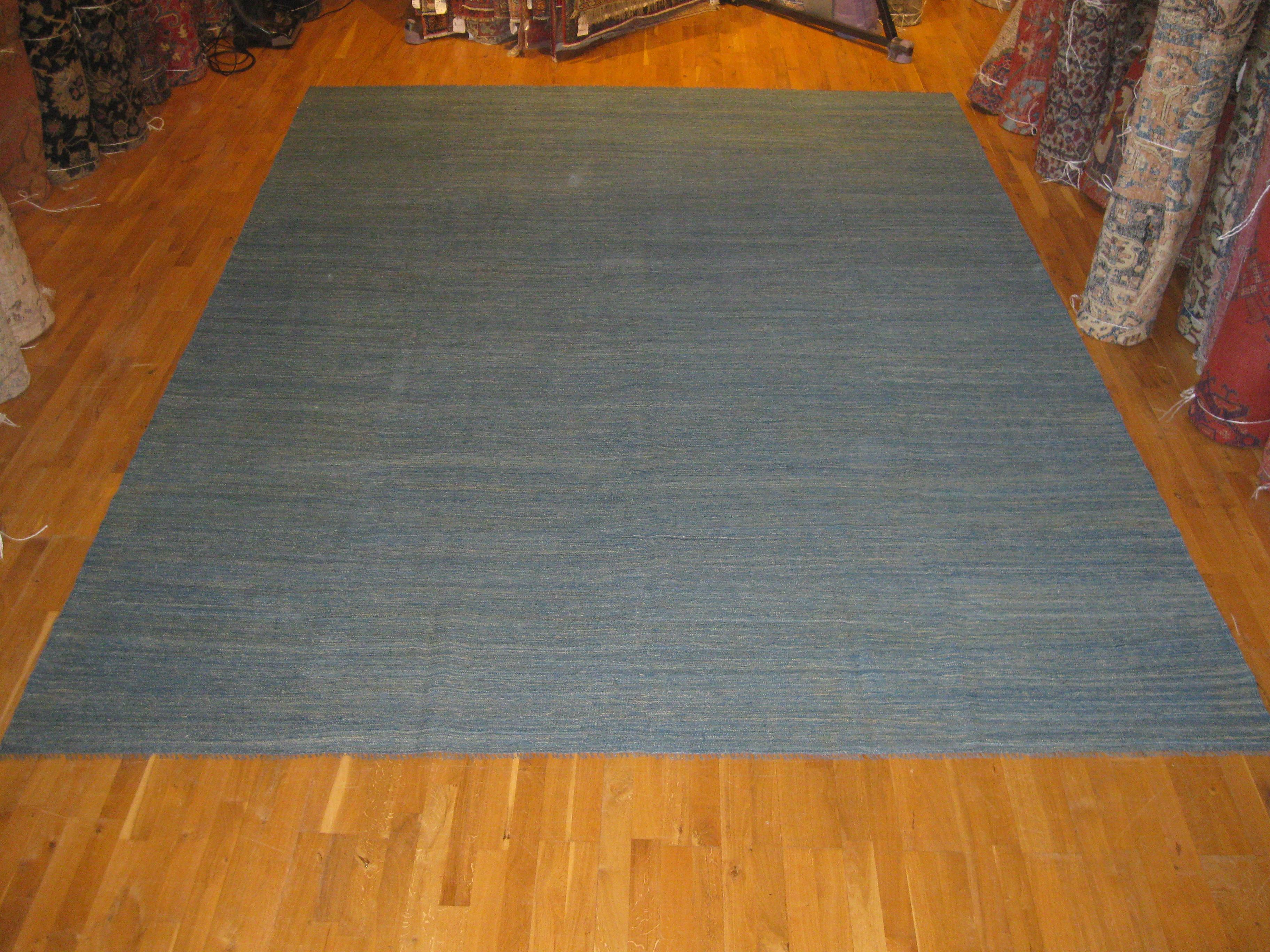 A sea of blue with subtle hints of gold and ivory. Kilims have a well-deserved popularity not least because they are reversible, easy to move and easy to care for. Use this large Kilim on its own or add another layer over to give a space a