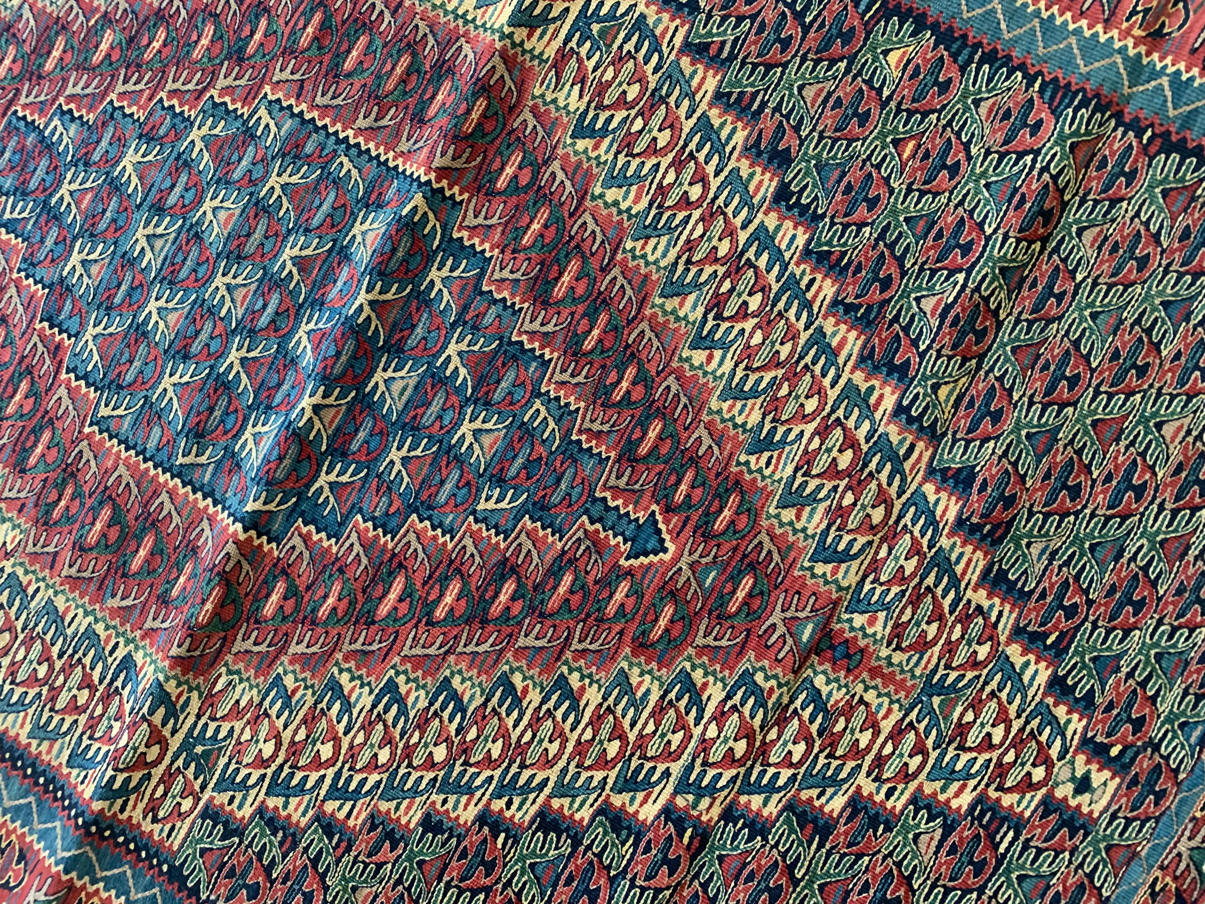 These elegant flatwoven area rugs are beautifully handmade kilim rugs, constructed with only the finest wool & cotton. The design features a large diamond medallion woven in accents of green, blue and red that have been intricately woven into