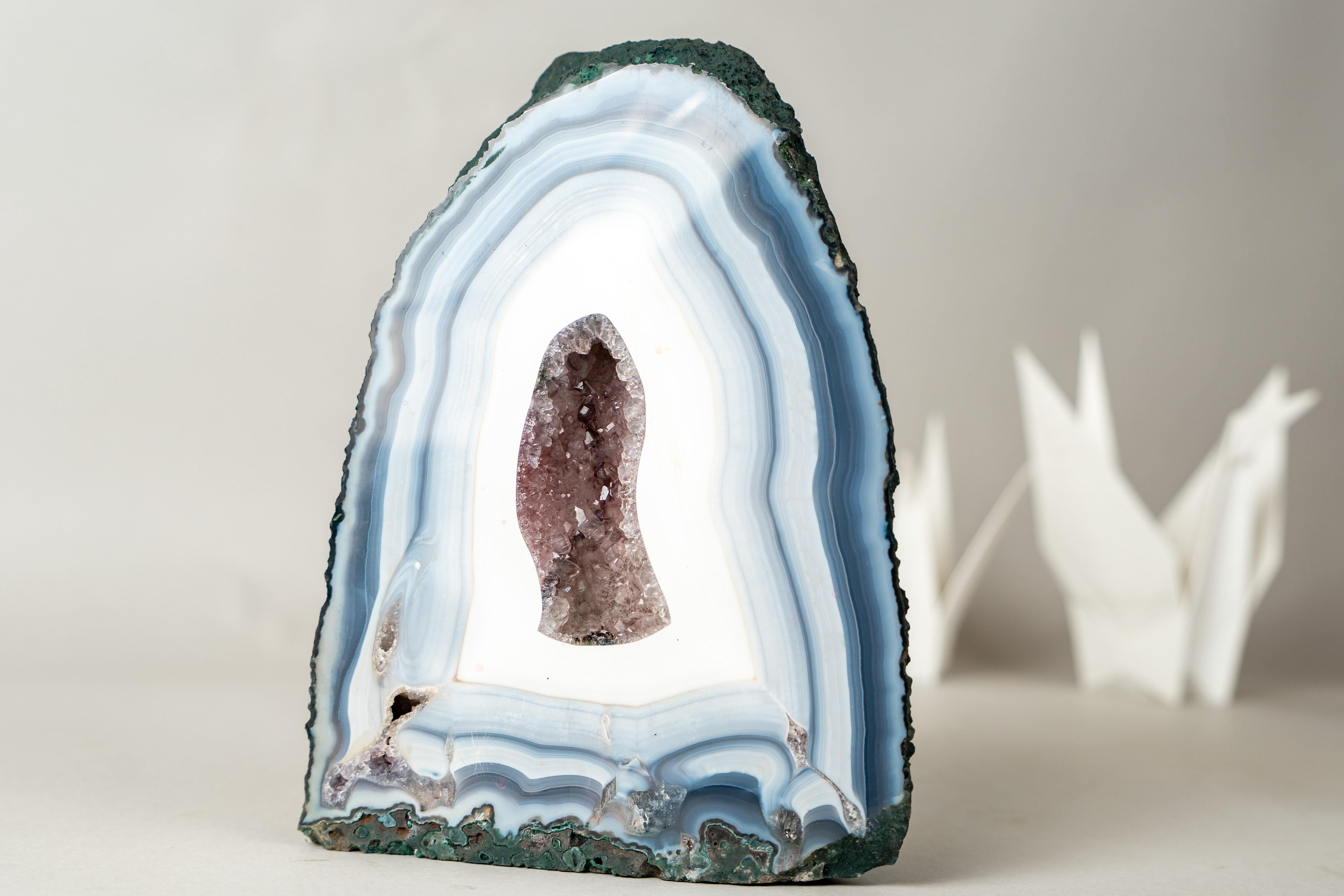 A Natural Agate Artwork: Rare Intact Blue and White Lace Agate Geode with Amethyst Core

▫️Description

Because of its perfectly arched shape, serene appearance, and cathedral-like symmetry, this agate geode was affectionately nicknamed “The