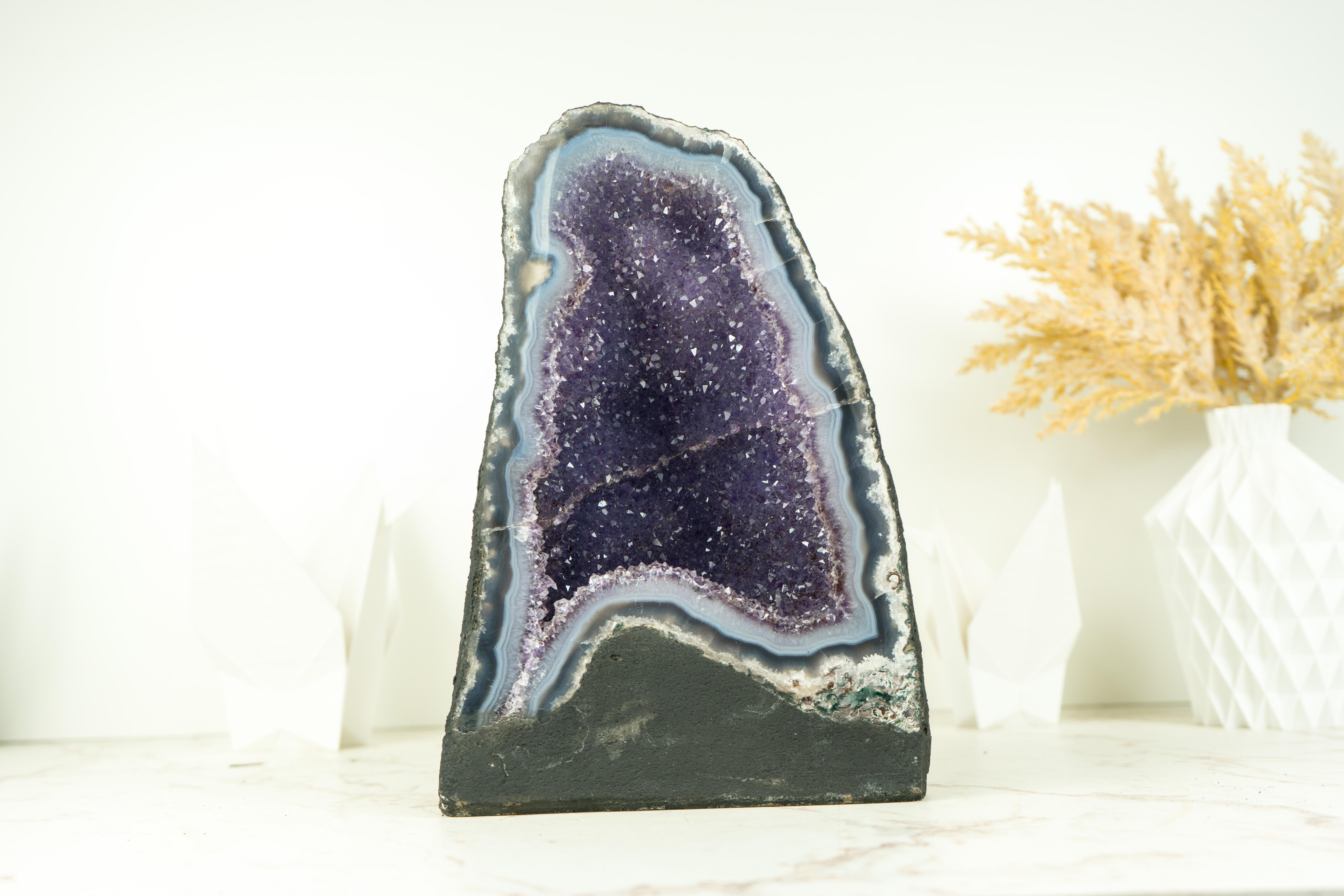 Small in size, this natural Agate Geode brings many rare characteristics that turn it into a natural artwork. Those characteristics, such as the blue agate band, the lavender galaxy druzy, and the perfection of its natural drawings will shine at