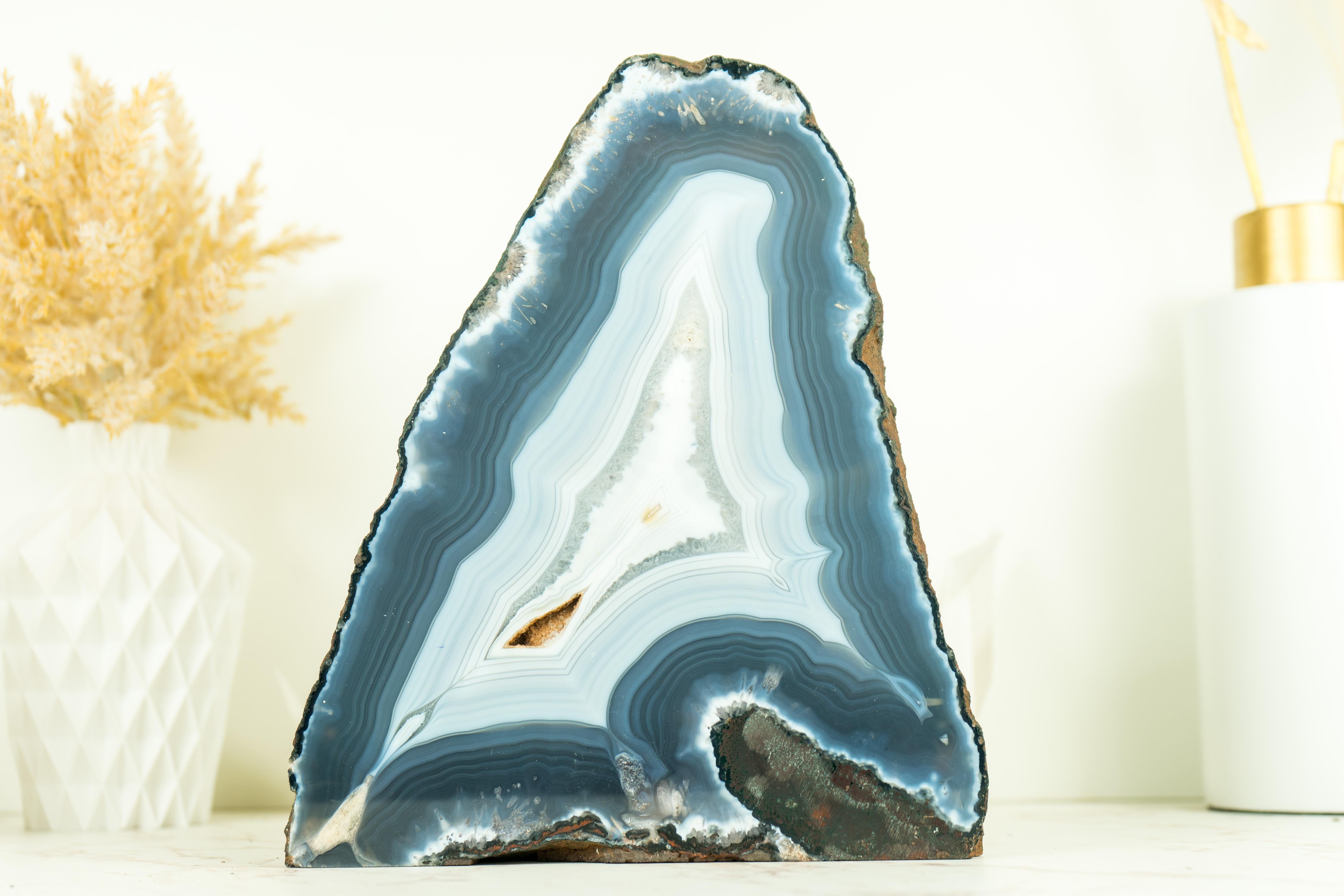 With Blue and White Laces, this Blue Banded Agate geode is a rare find, gorgeously showcasing what nature is capable of making. This specific specimen comes from our Father's collection of world-class agates and from time to time he makes a specimen